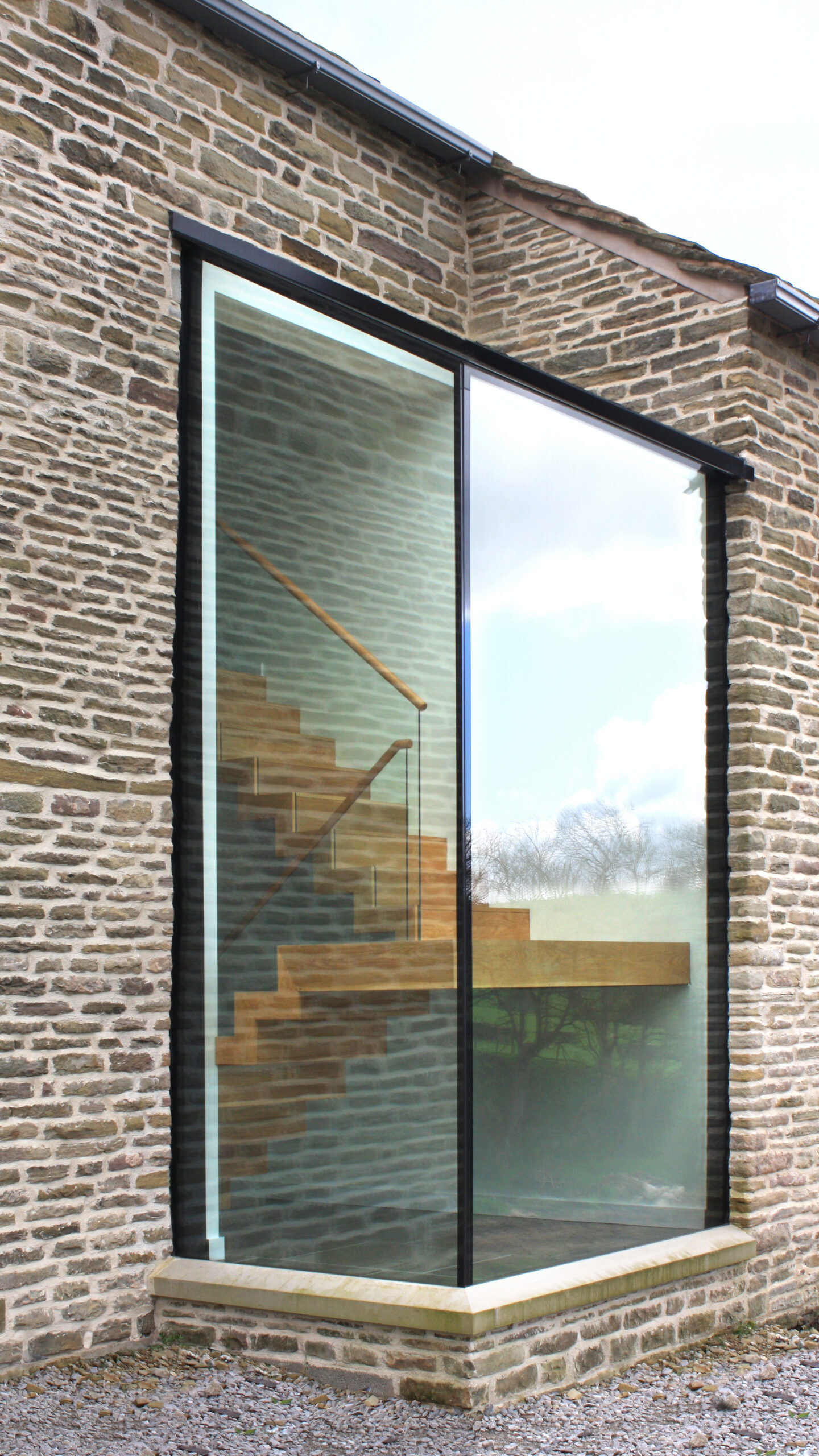 glazed box addition to listed barn conversion