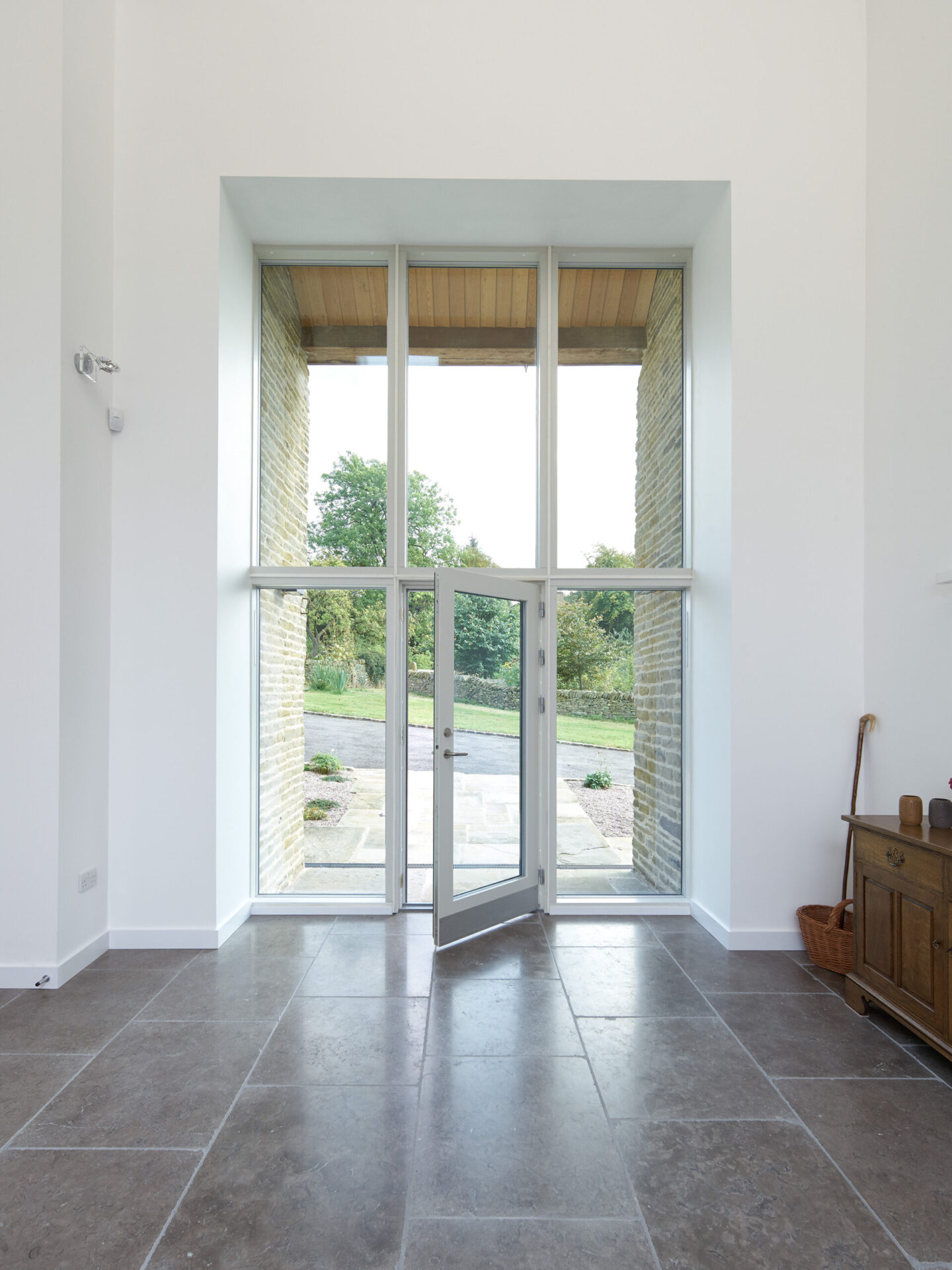 Original openings reused with double height glazing in barn conversion