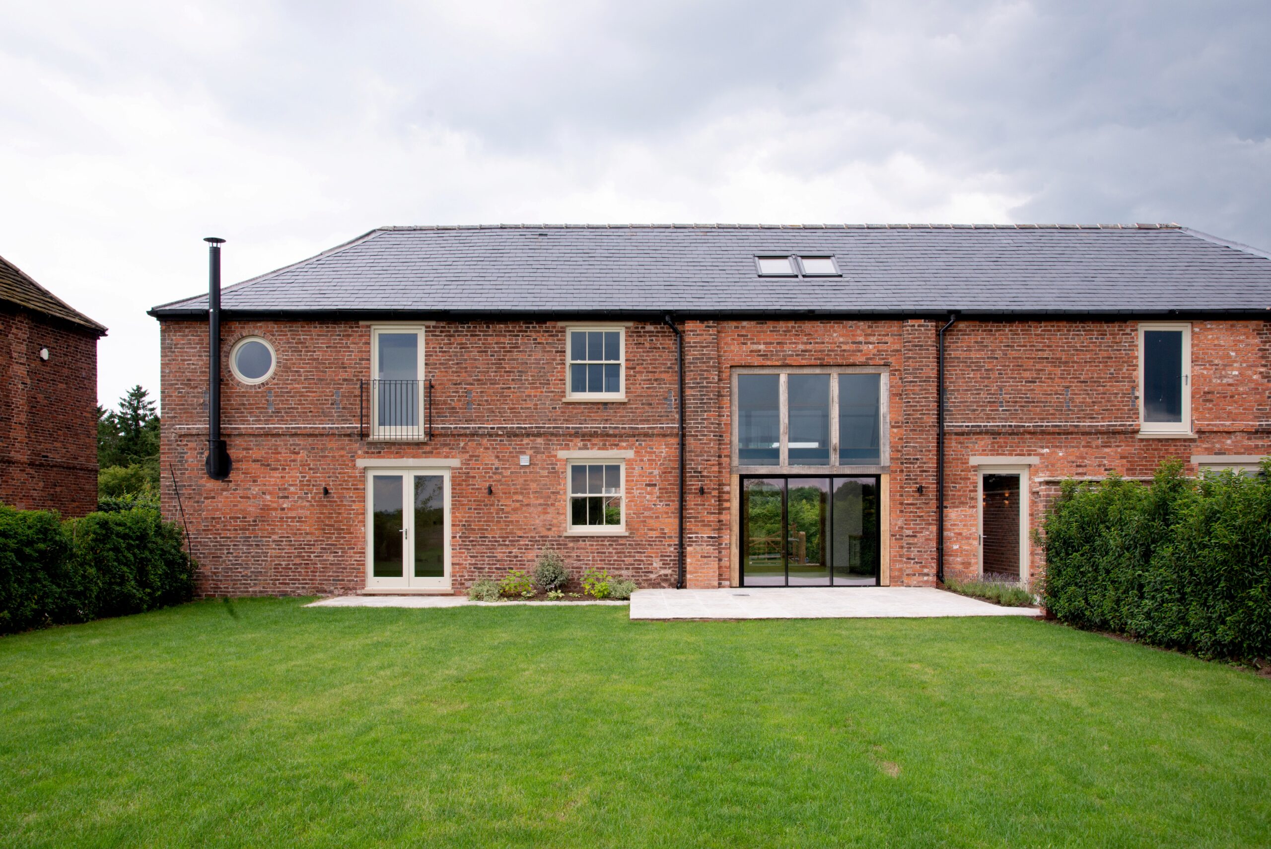 rear elevation showing large coach house openings and assortment of opening sizes