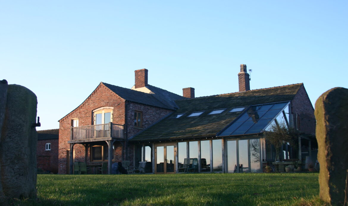 Rear elevation of a farmhouse with new rear extensions including a oak framed glazed garden room