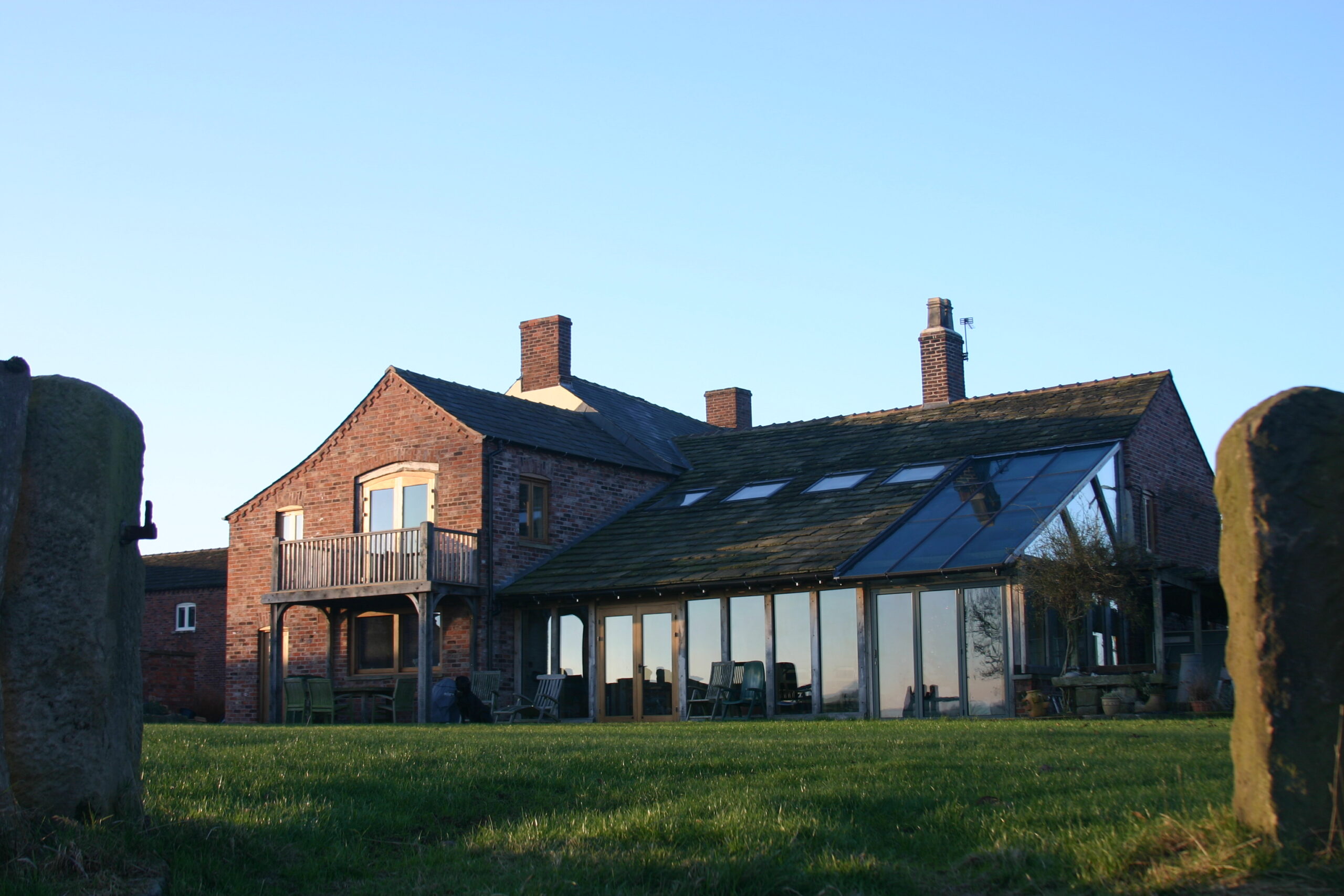 Bank Farm House Rear elevation of a farmhouse with new rear extensions including a oak framed glazed garden room