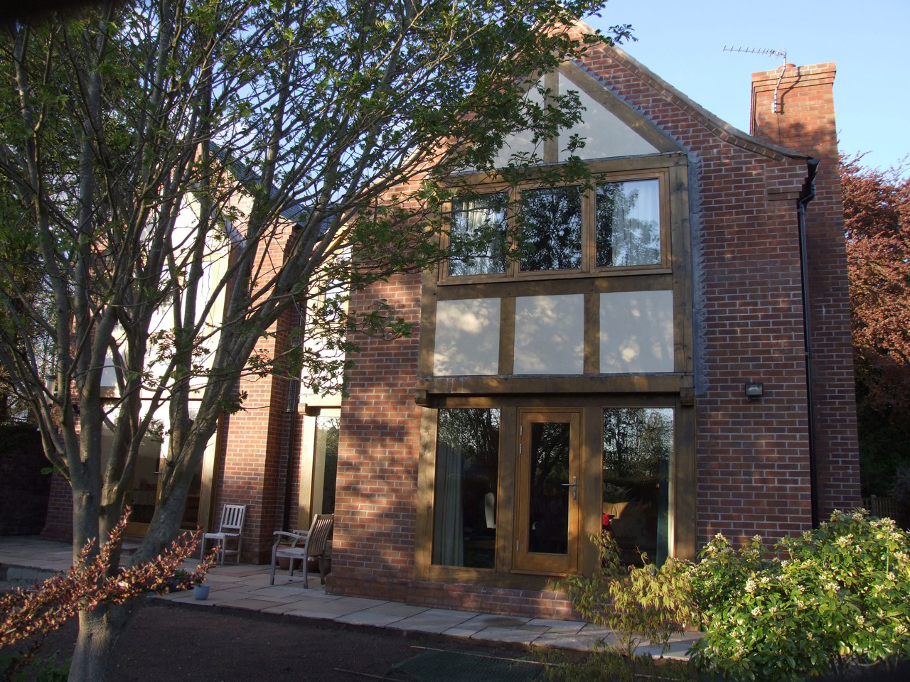 brick rear elevation of Byrons Lane with oak framed glazing
