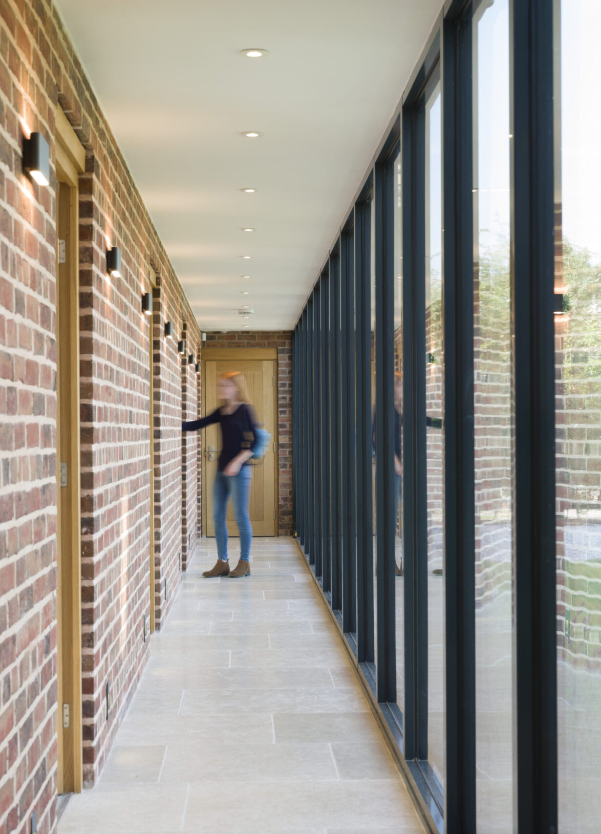 glazed corridor with access to bedrooms and garage