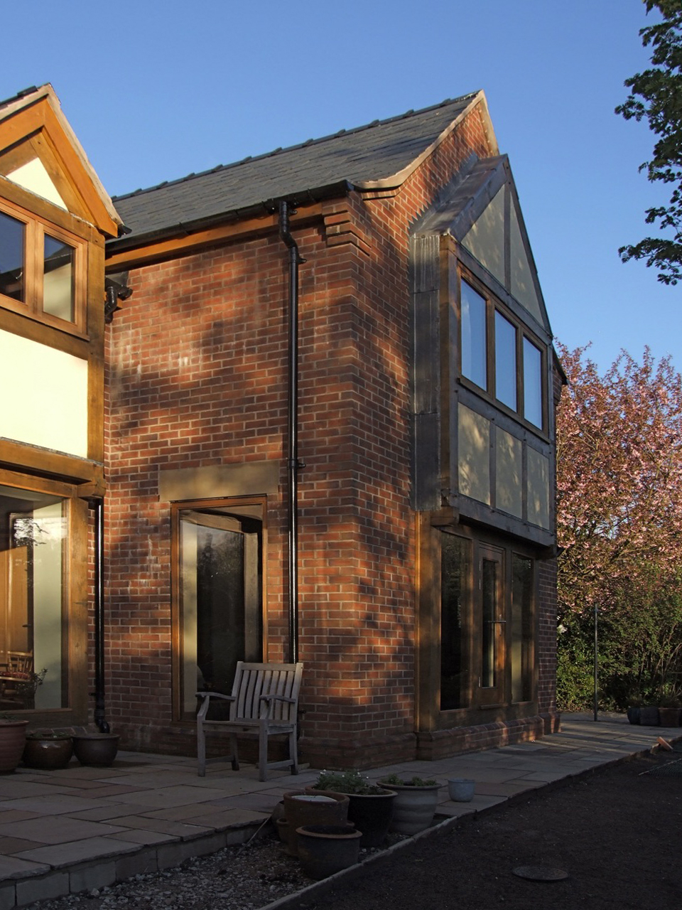 oak frame glazing protruding from brick replacement dwelling