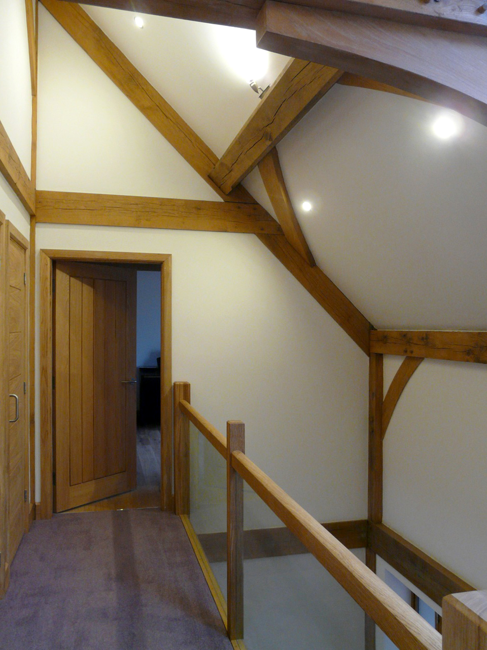landing area with glass balustrade and exposed timber structure