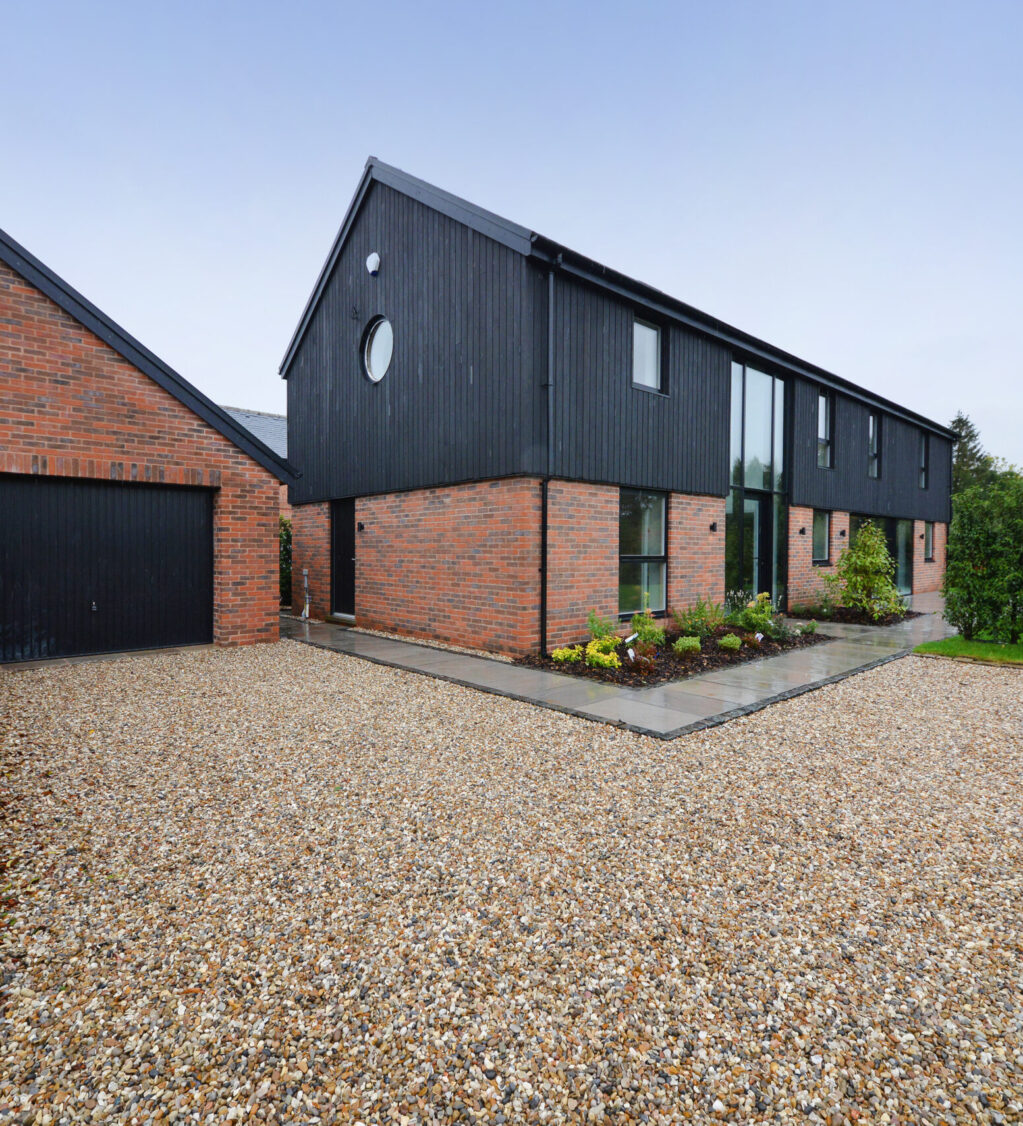 image from driveway showing the replacement dwelling and garage building at New Orchard Barn
