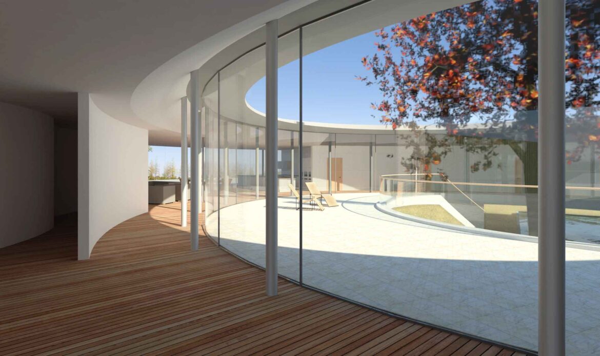 internal view of internal courtyard and circular glazed corridor all centred around a large tree