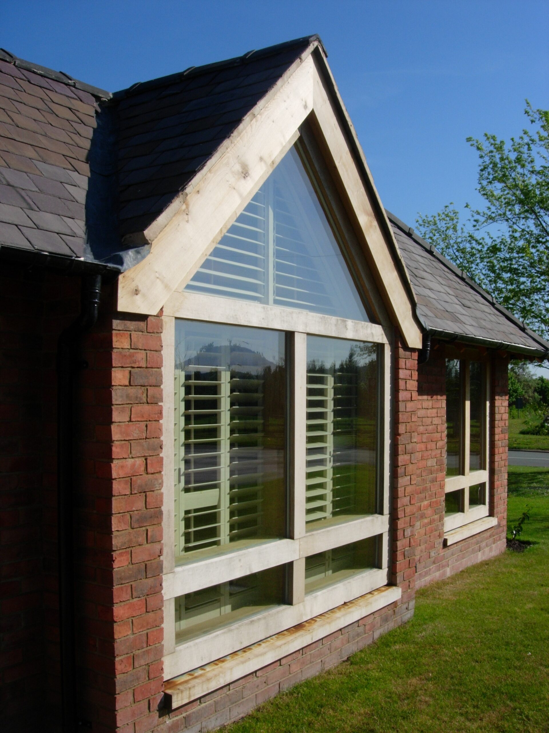 new window with triangular glazing and oak framing
