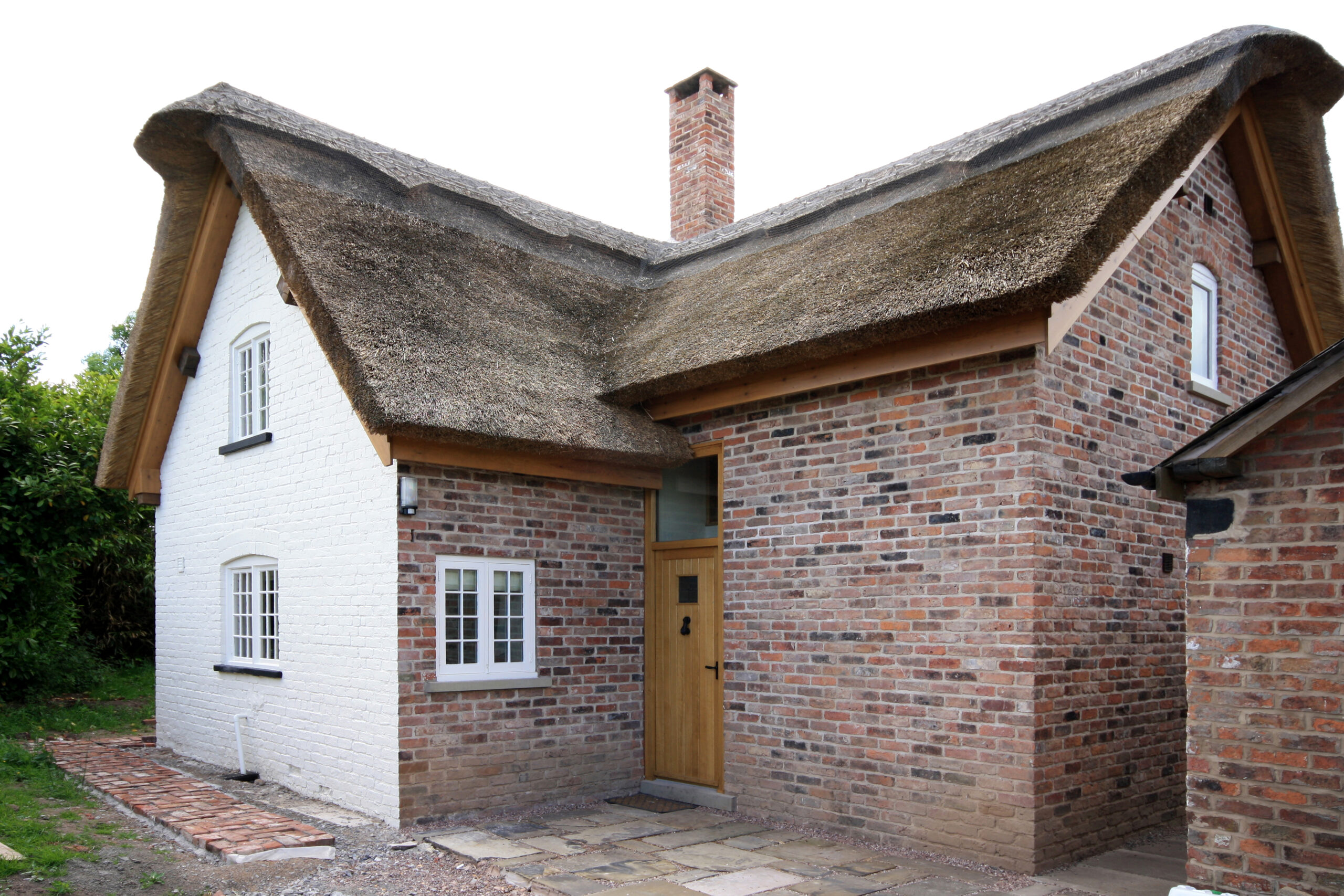 Blakehouse Cottage brick extension new brick extension with new thatched roof