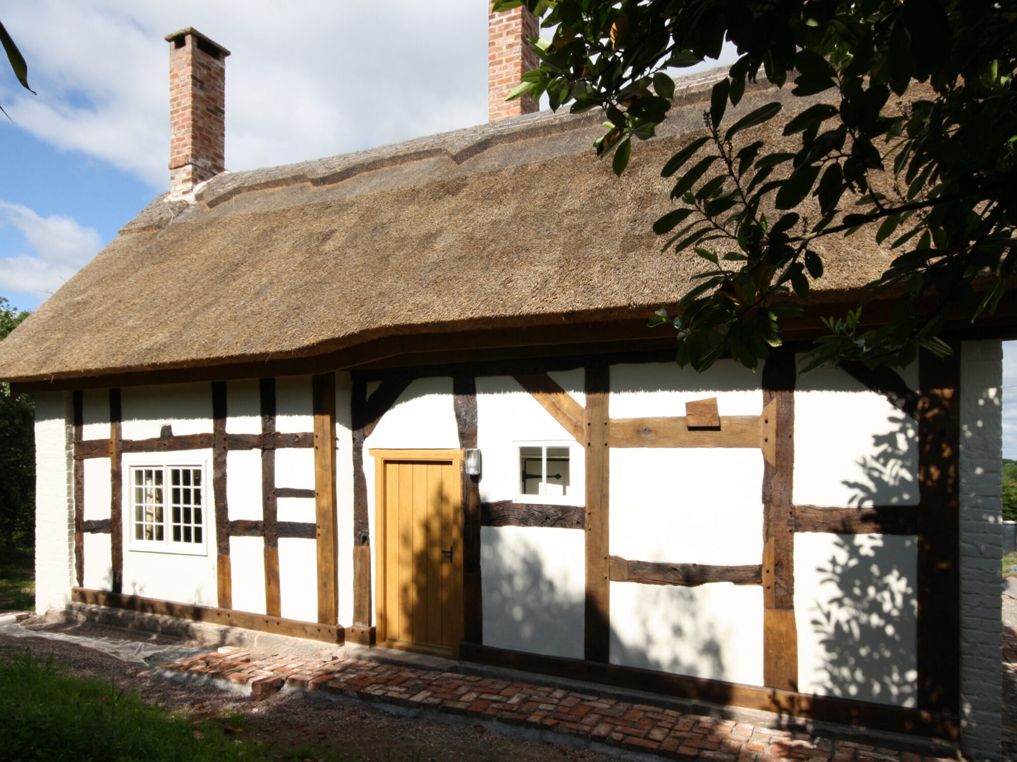 insulated panels infilled between existing timber structure with new thatched roof