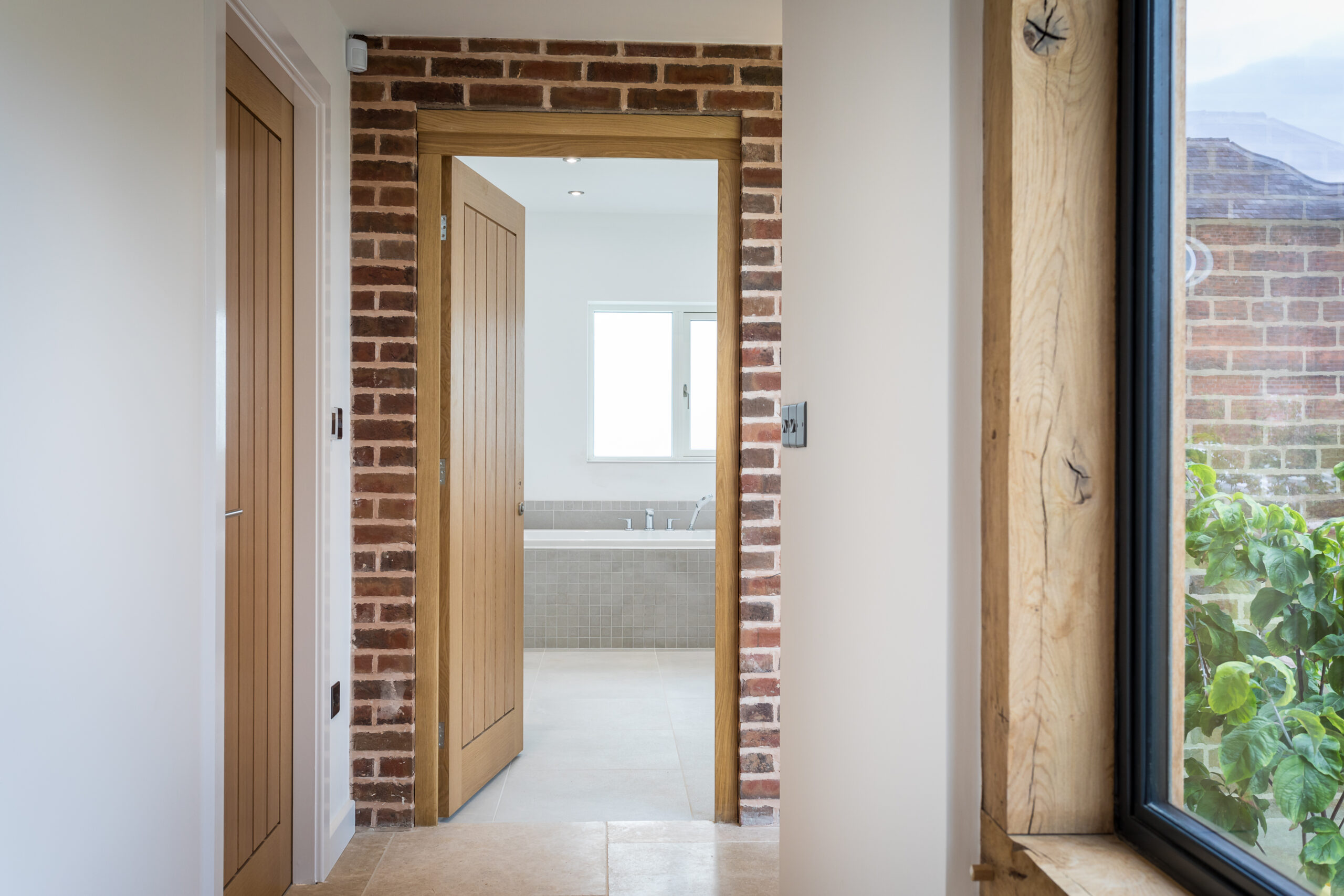 Dovecote Cottage hallway with exposed brick wall