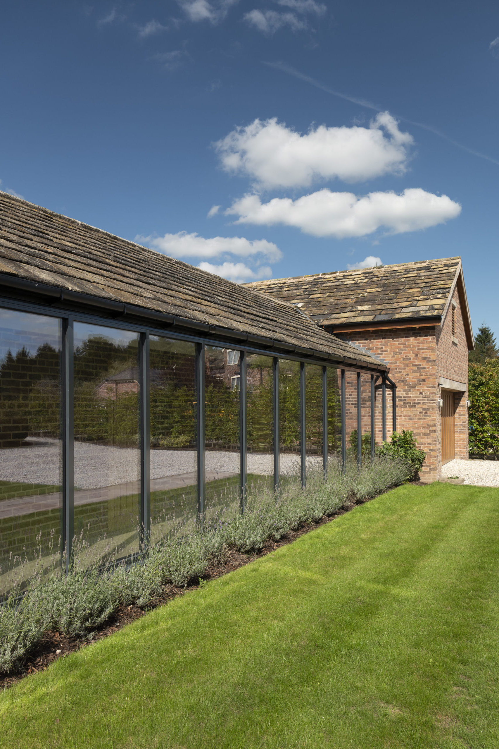 glazed corridor bringing natural light into the dwelling with garage block addition