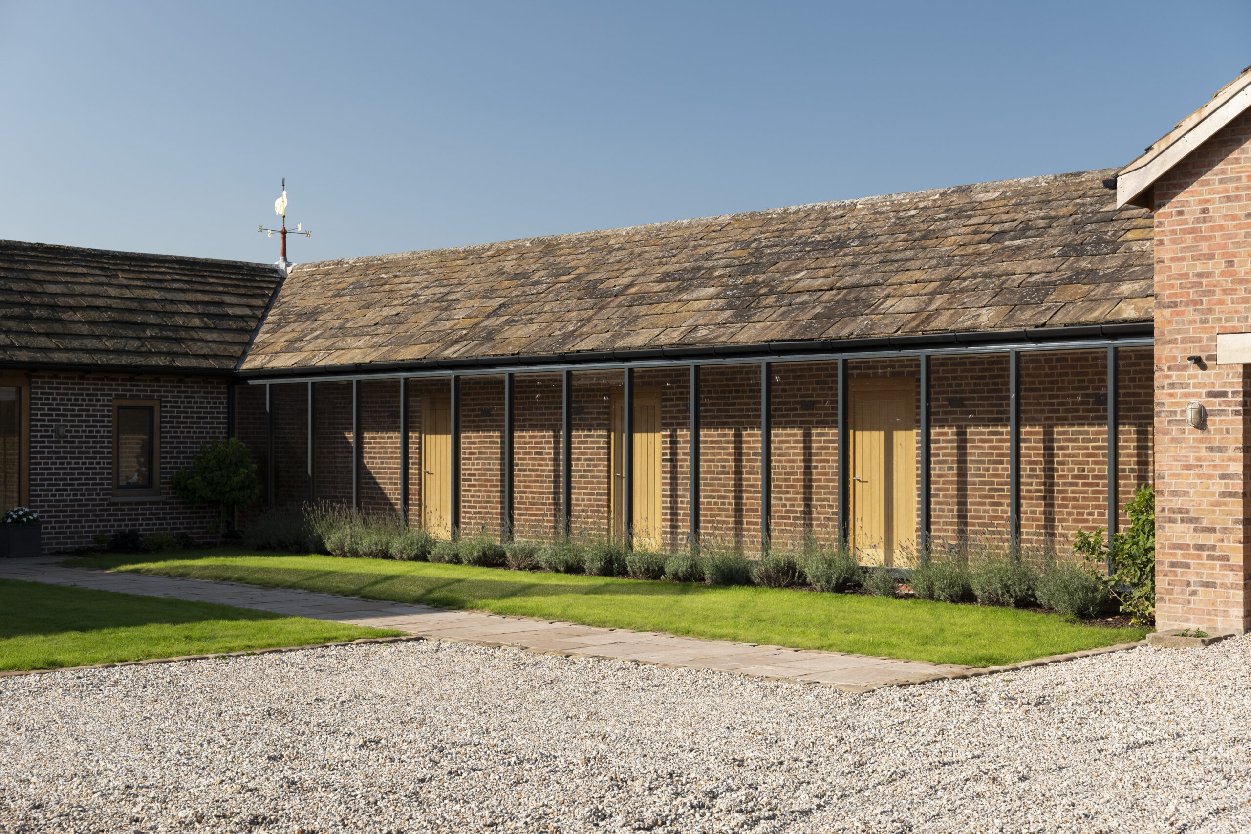 glazed corridor bringing natural light into the dwelling with garage block addition