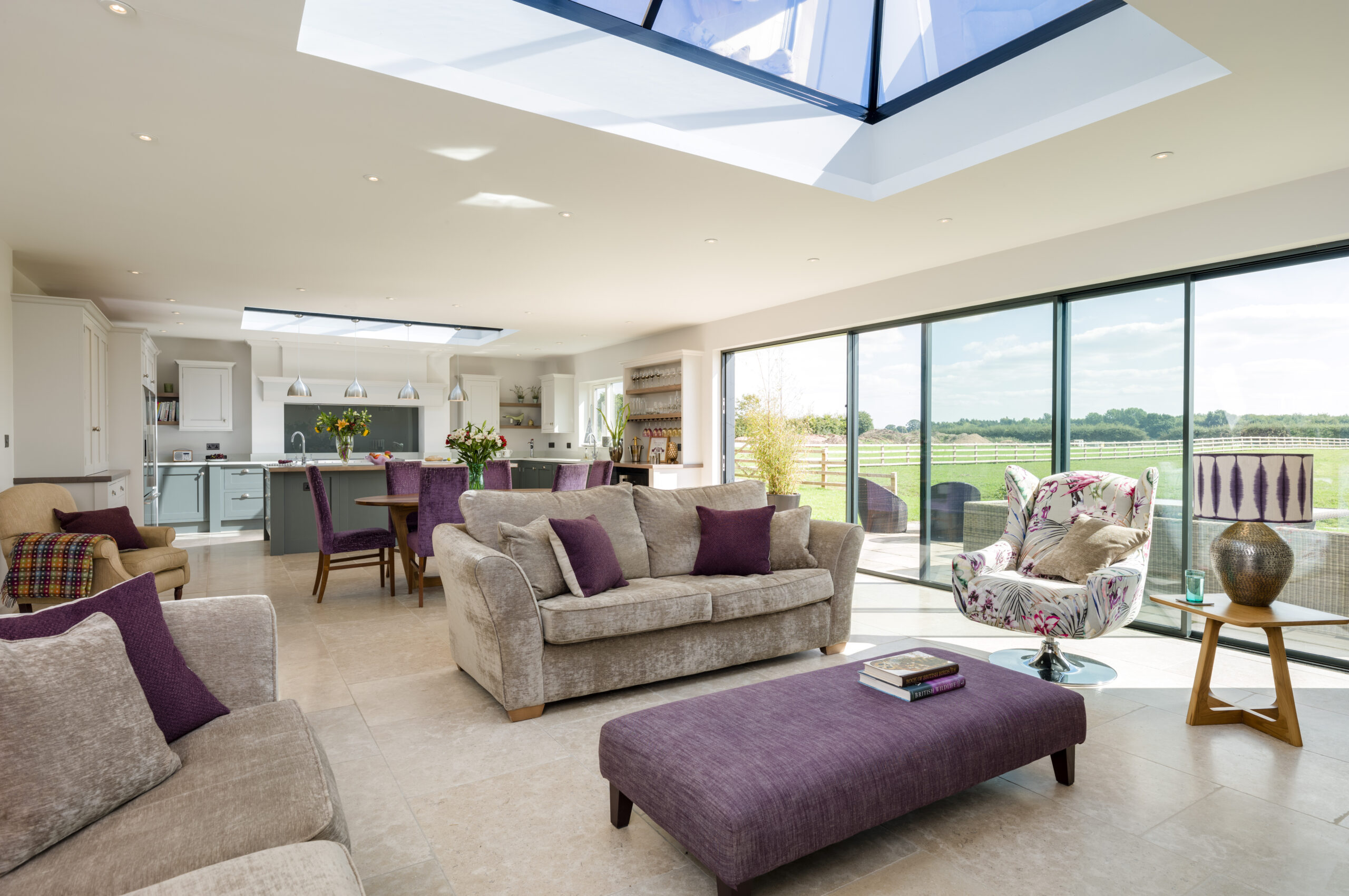 open plan kitchen, dining and living space with roof lantern in the next single storey extension with sliding doors opening onto the rear garden patio