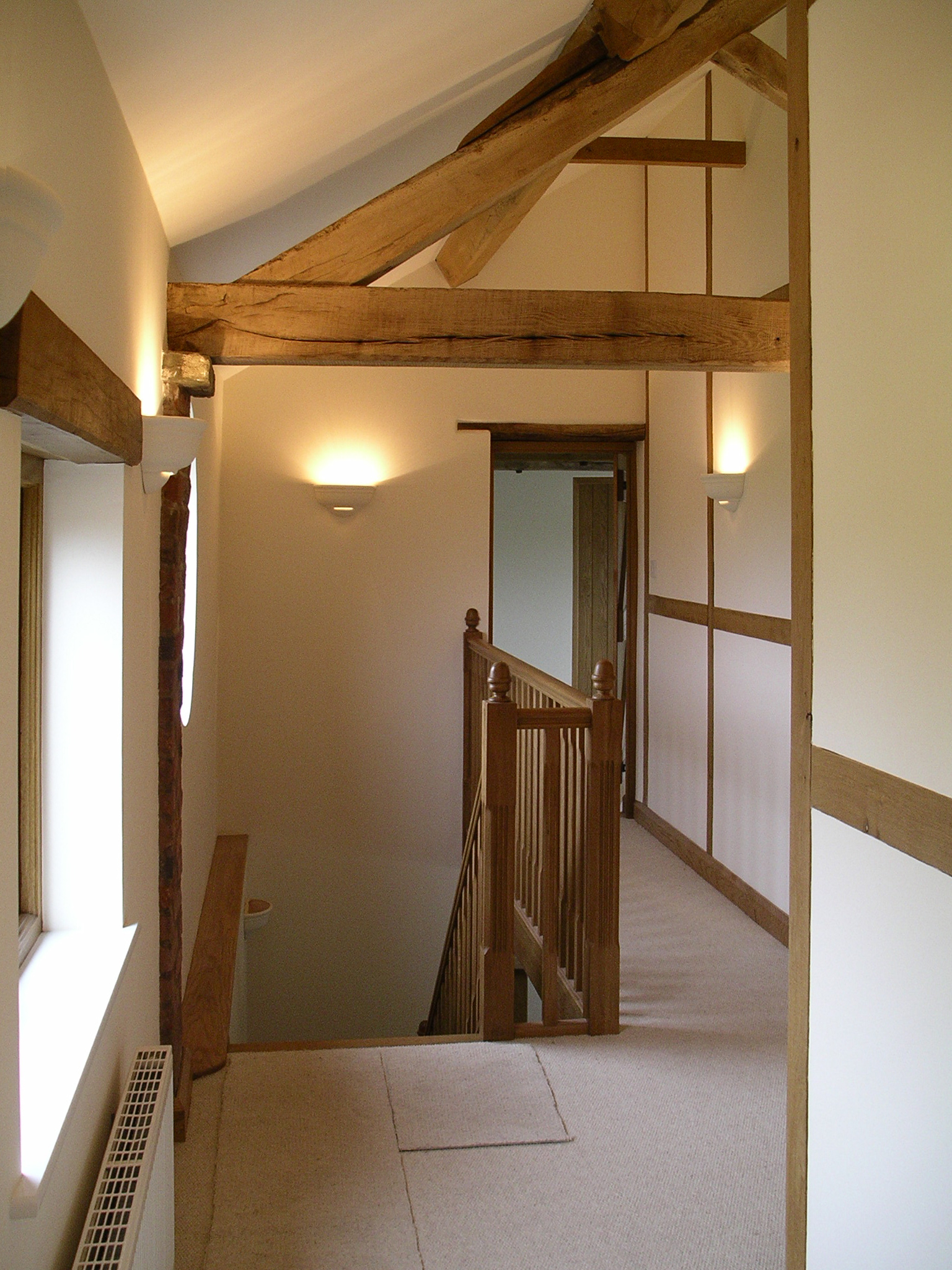 exposed timber roof structure to converted barn with exposed timber window and door heads