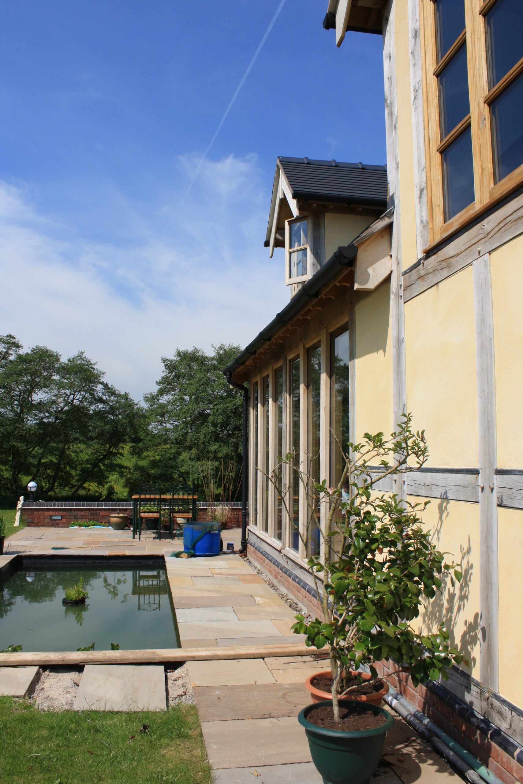 rear garden with pond and paving