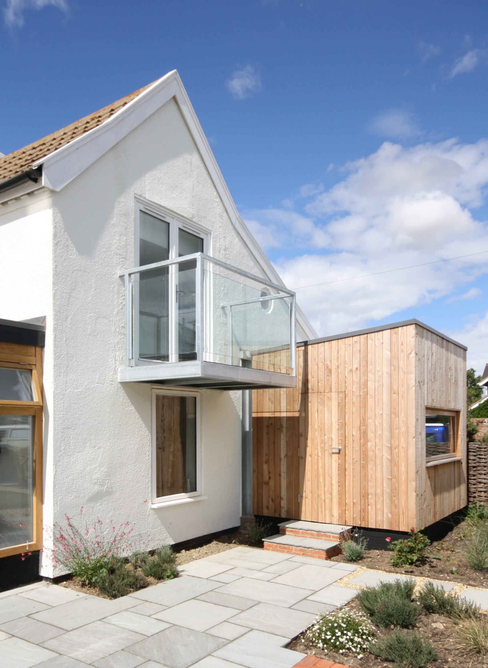 existing rendered house with new timber clad rear extension containing the clients office