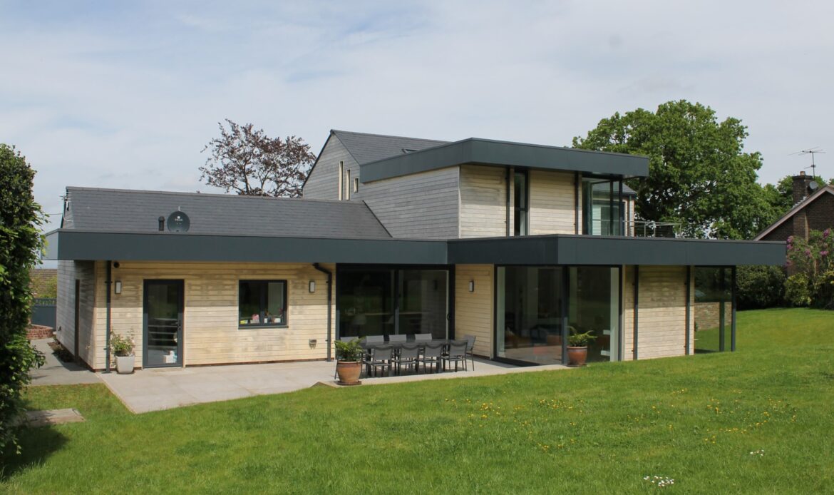 contemporary rear elevation with timber cladding and metal overhanging roof
