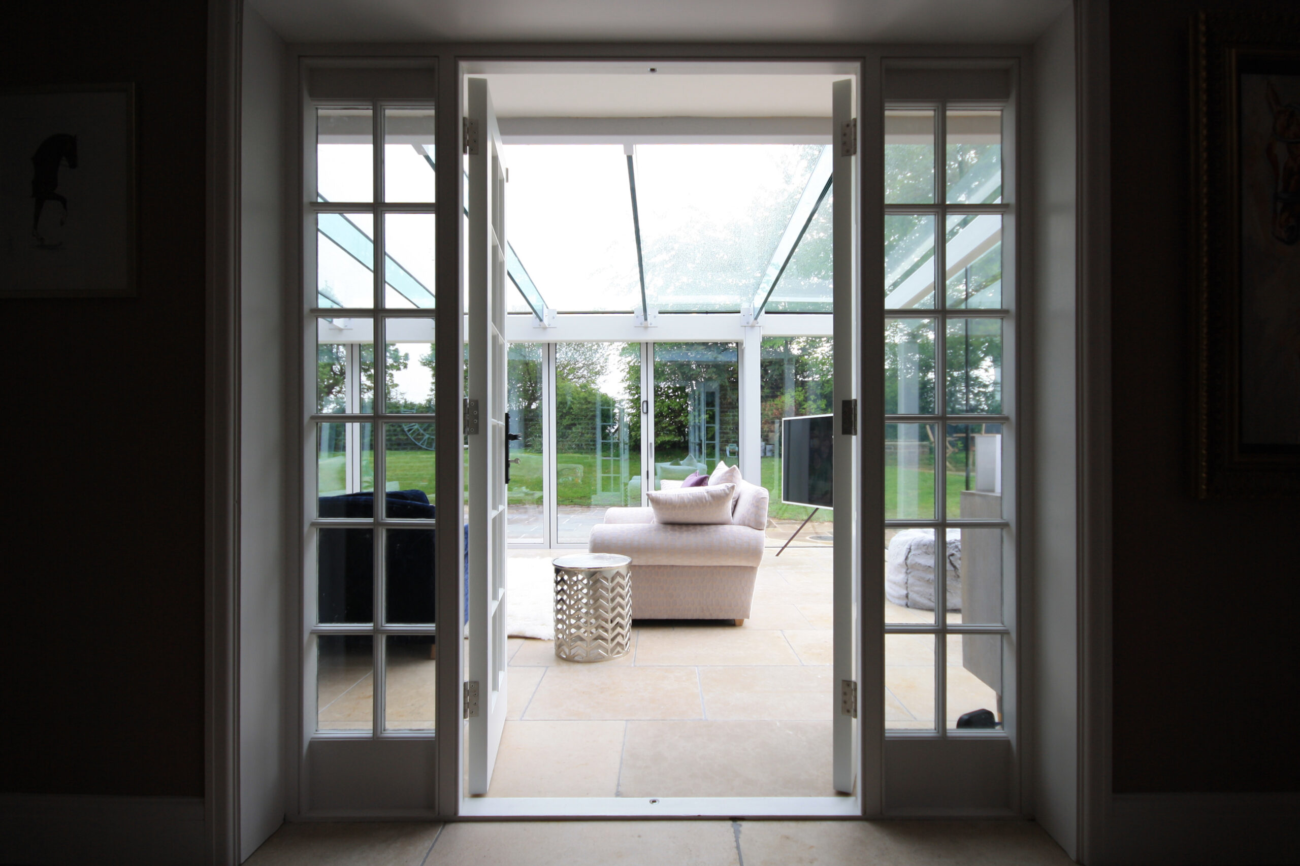 view from the entrance hall into the conservatory and onto the rear garden
