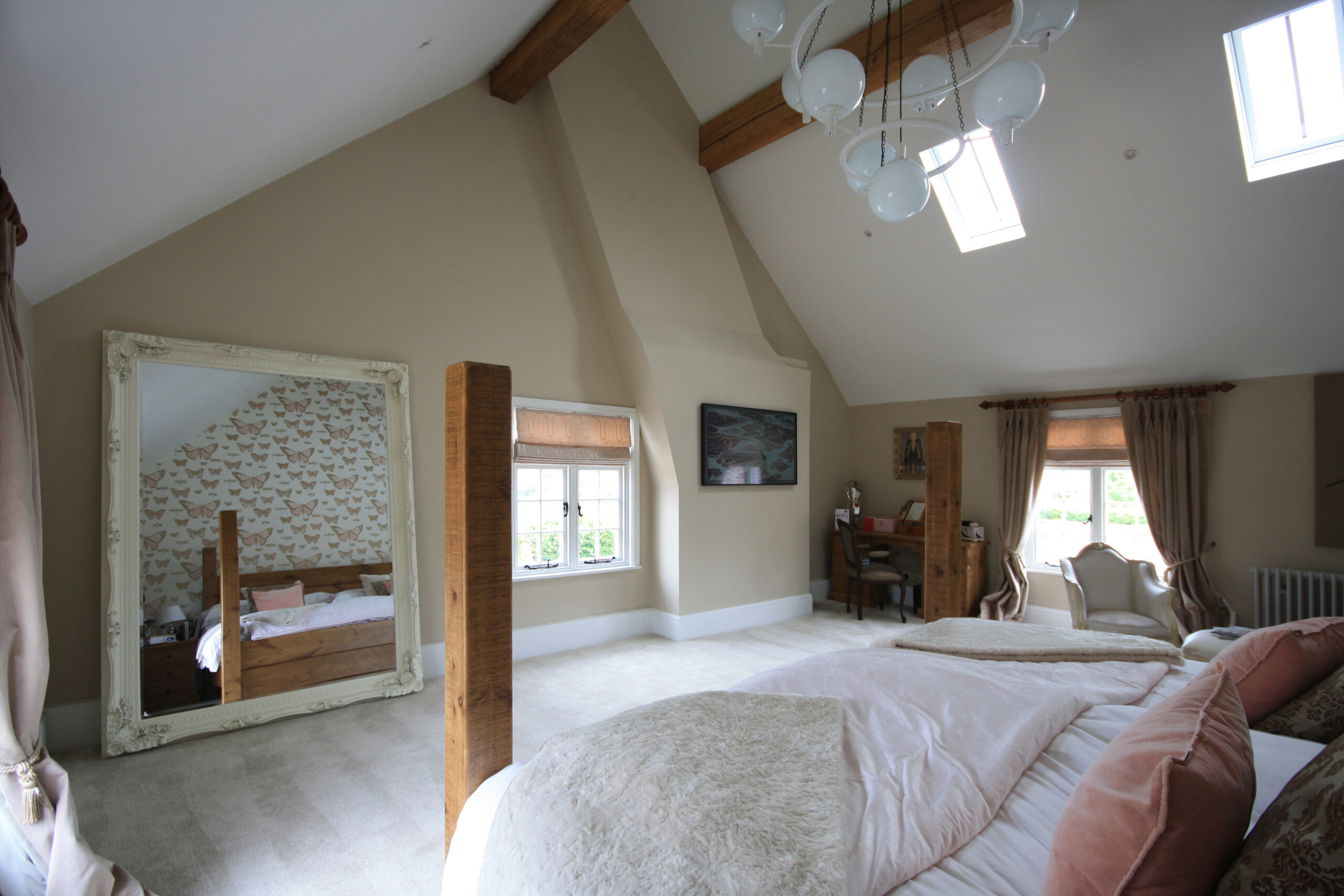 bedroom with tall raked ceilings, exposed timber roof purlins and chimney