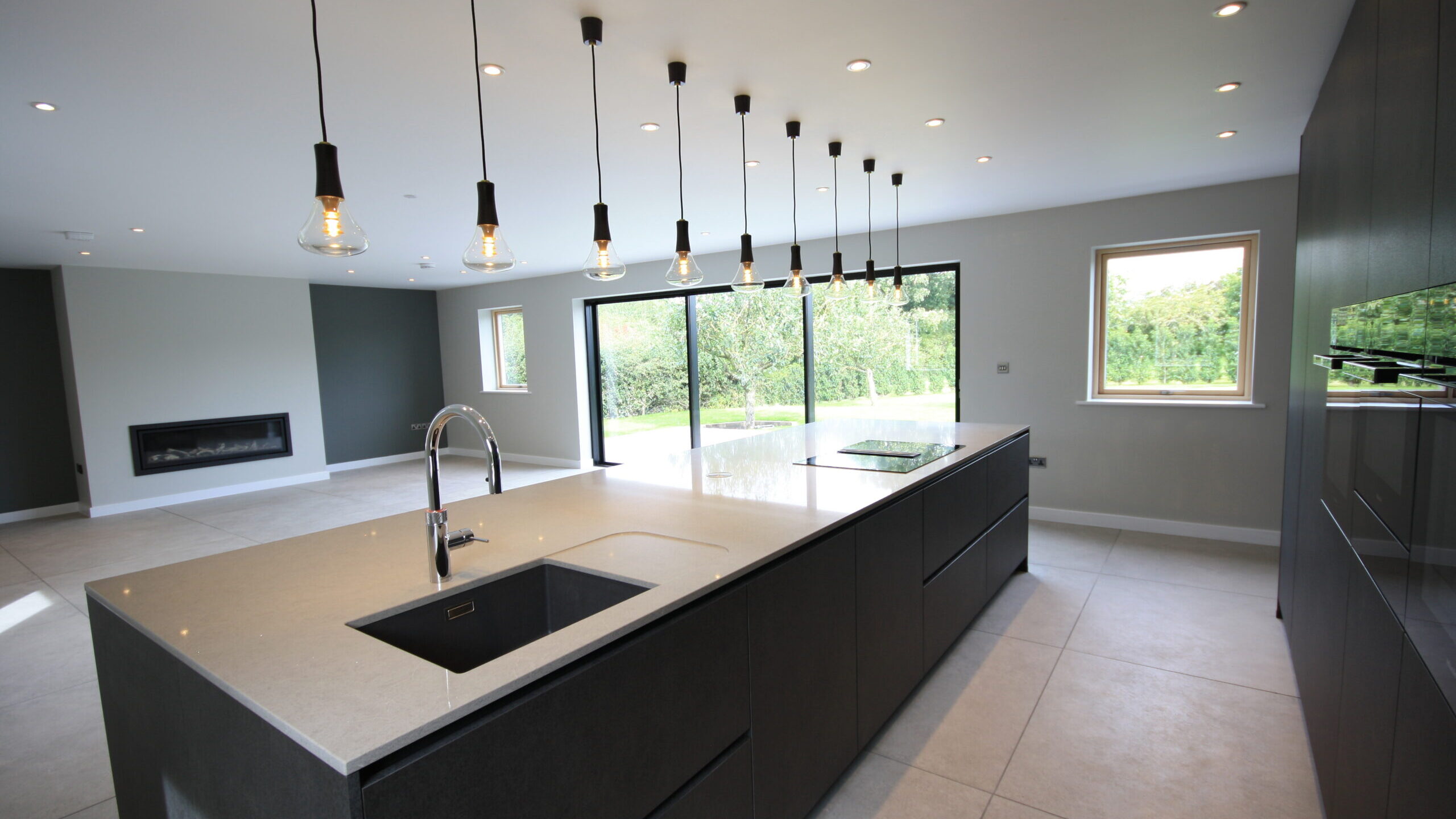 modern kitchen and living area with sliding doors onto the rear patio area