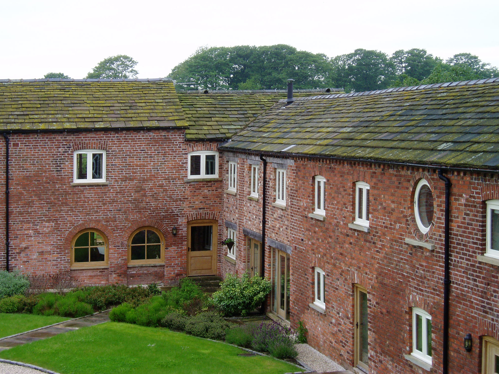converted brick barns with existing opening retained