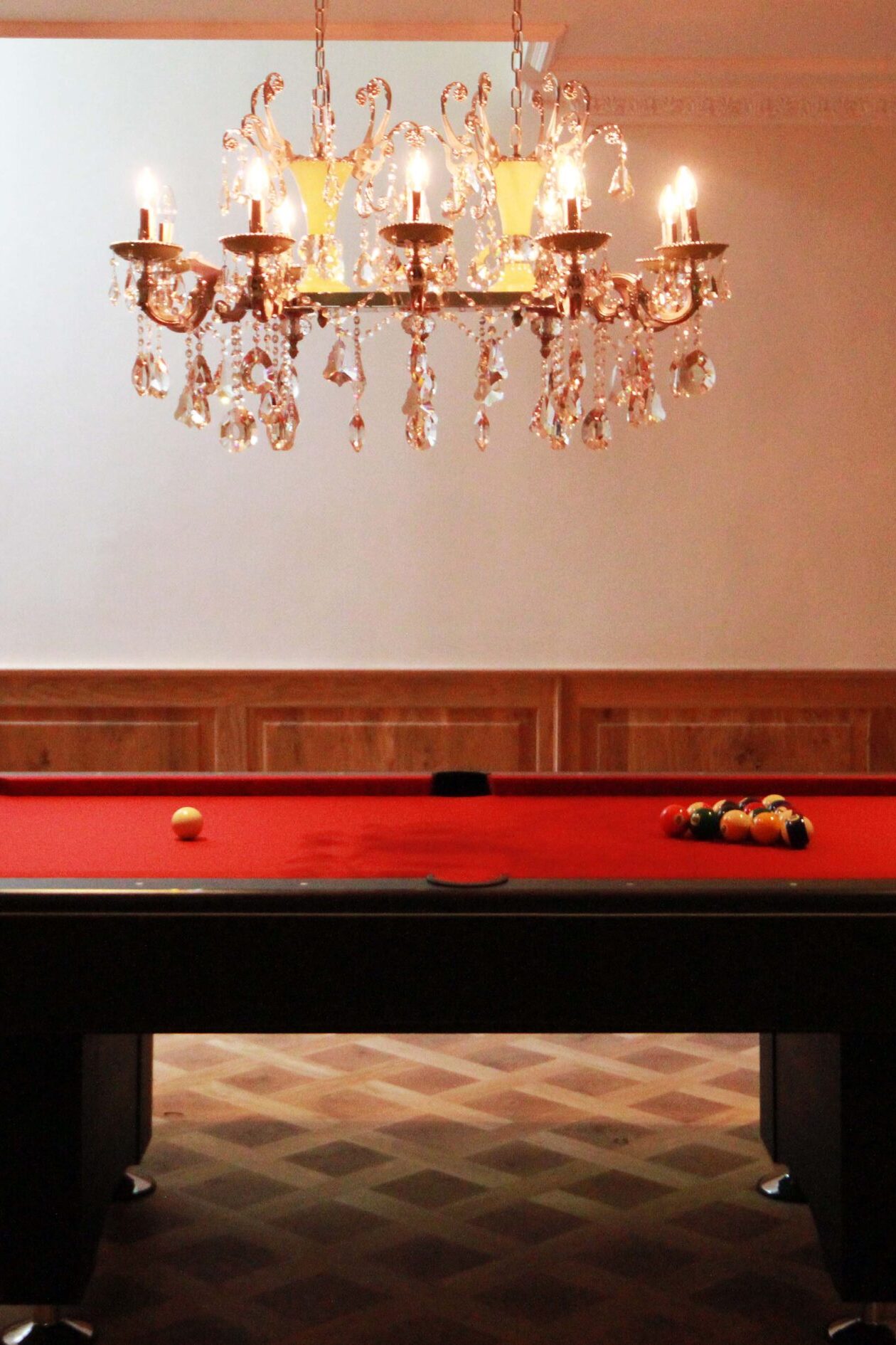 Prestbury Road entertaining room pool table with chandelier fitting above