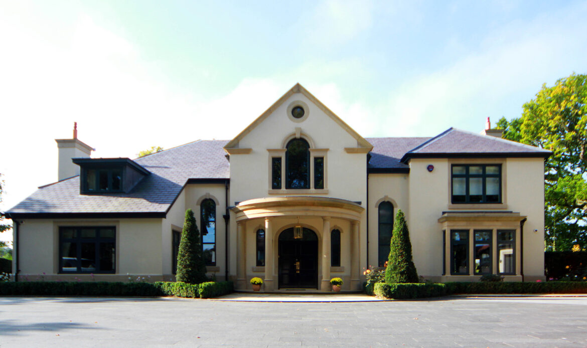 render finish replacement dwelling with stone portico and detailing