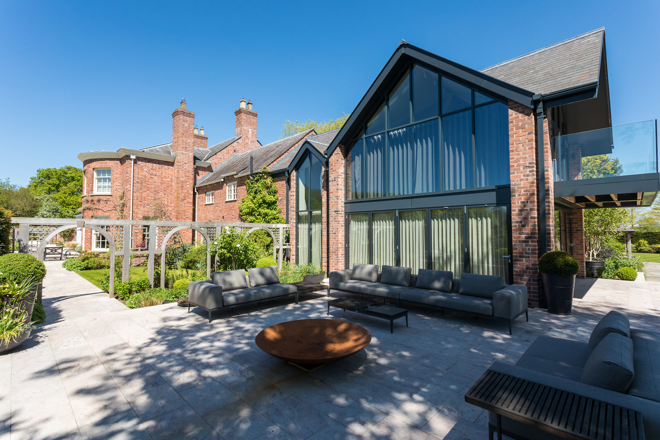 Ash House extensions at Ash House with external seating area and firepit in curated gardens
