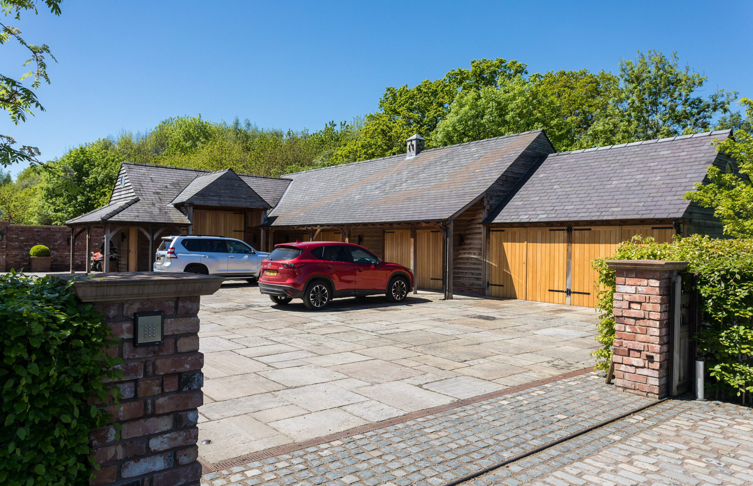 Ash House garage block Detached garage building at Ash House with external timber cladding