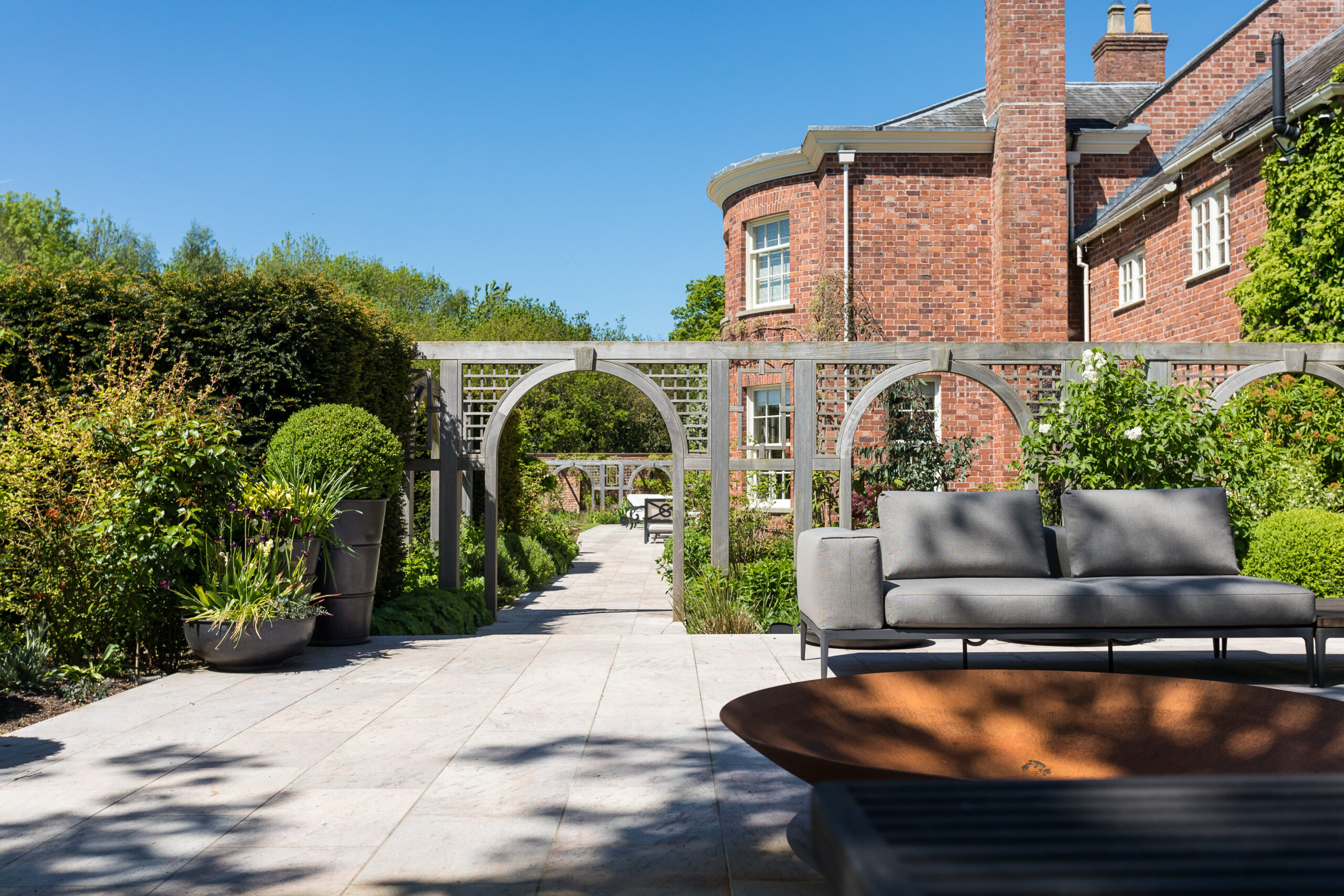 external seating area and firepit in surrounding gardens at Ash House