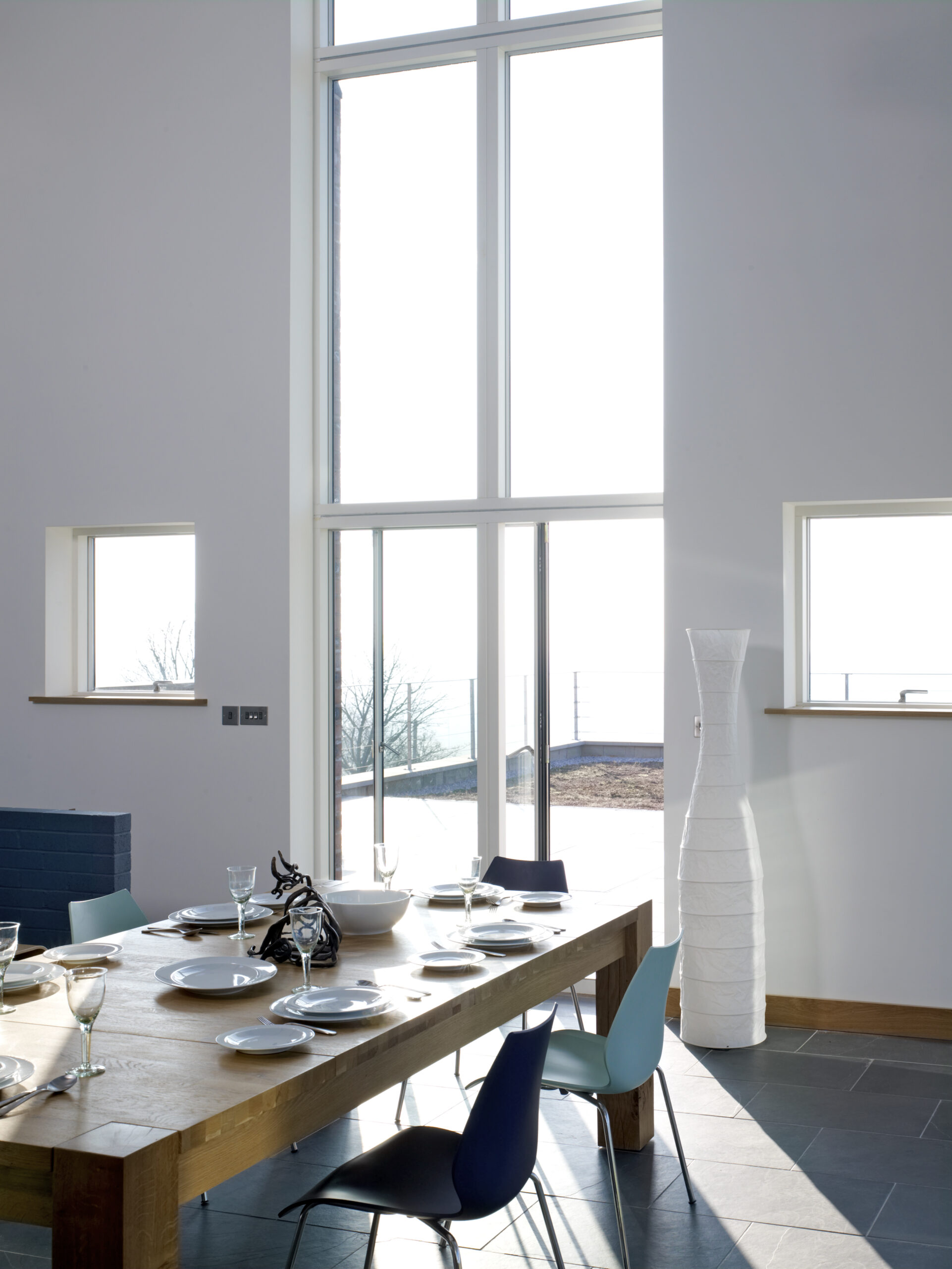 open plan kitchen area with a view out the full height glazing onto the external patio area and Cheshire hills