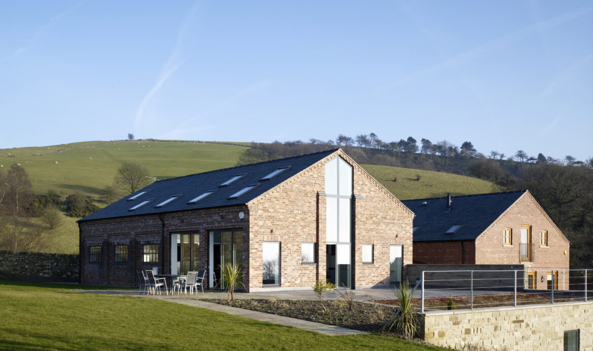 Converted brick barn set within elevated farmland within Cheshire