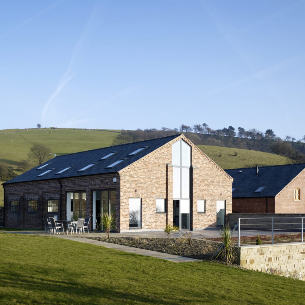 Converted brick barn set within elevated farmland within Cheshire
