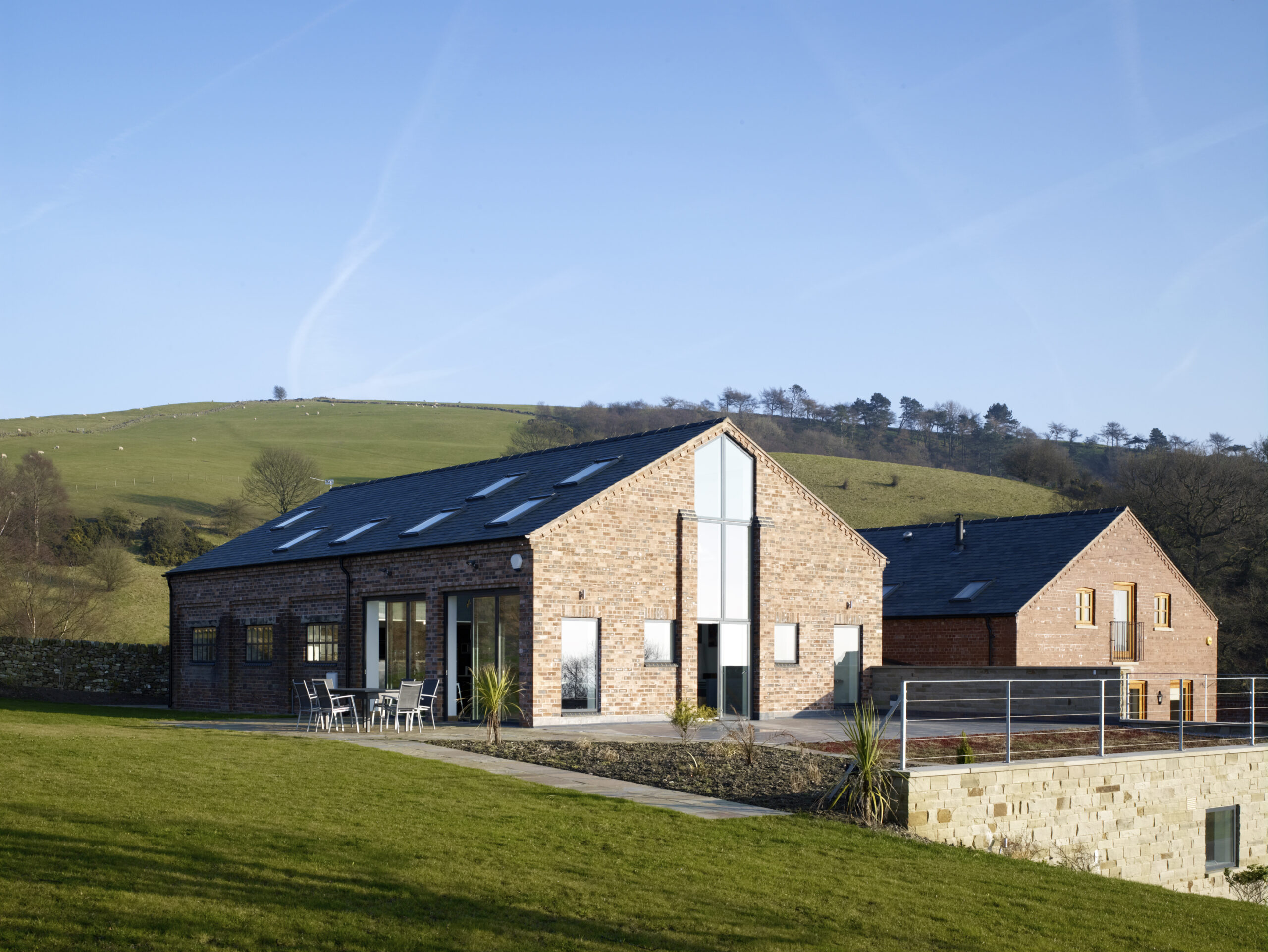 Converted brick barn set within elevated farmland within Cheshire