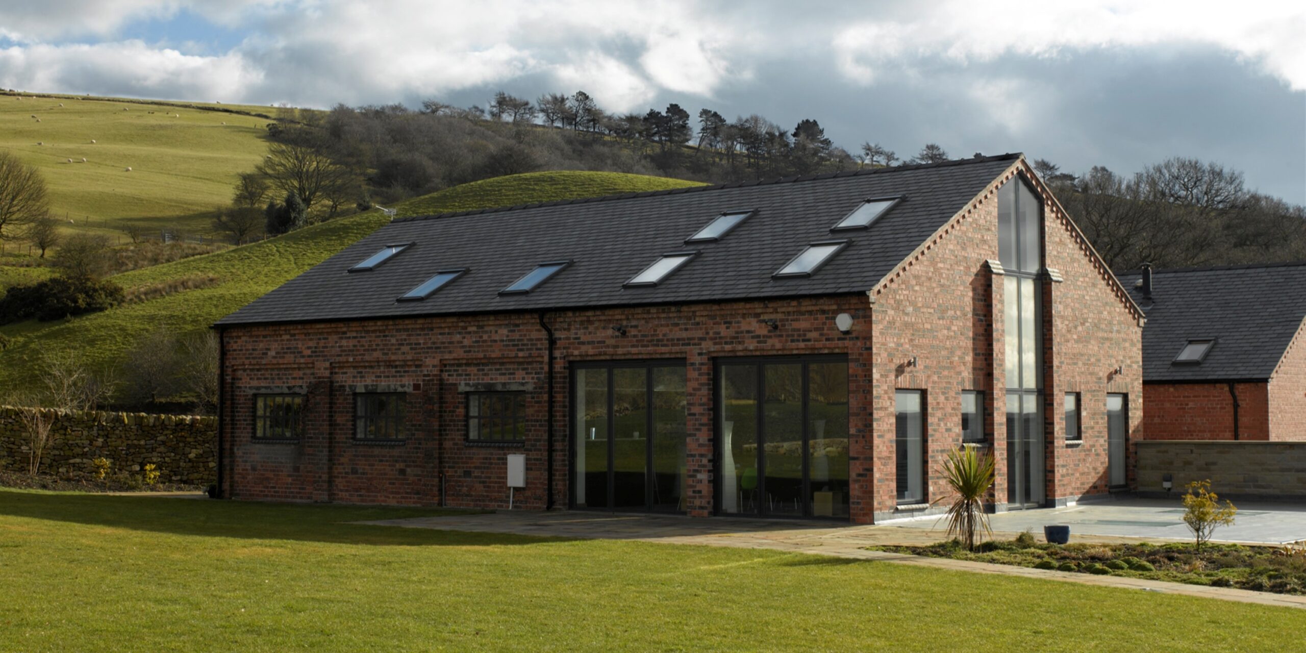 Converted brick barn set within elevated farmland within Cheshire