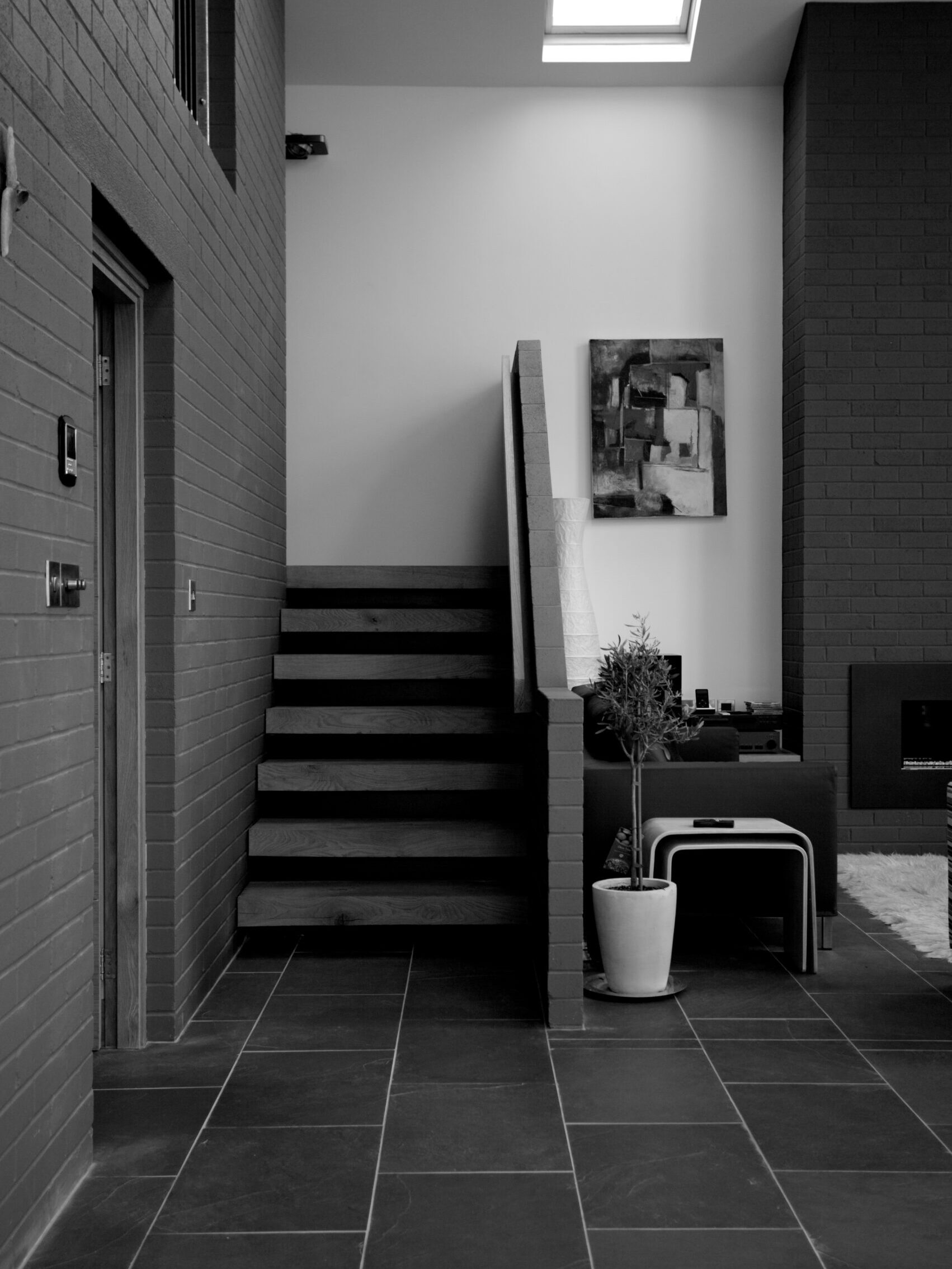 open staircase with brick balustrade and timber treads