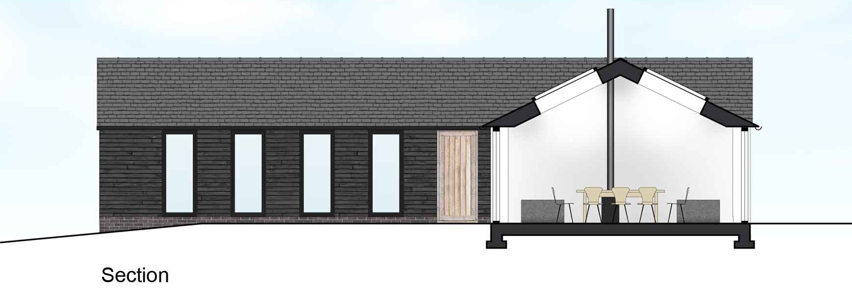 coloured section of The Stables with black timber cladding and glazing and rooflights within the dining area providing views through to the paddocks