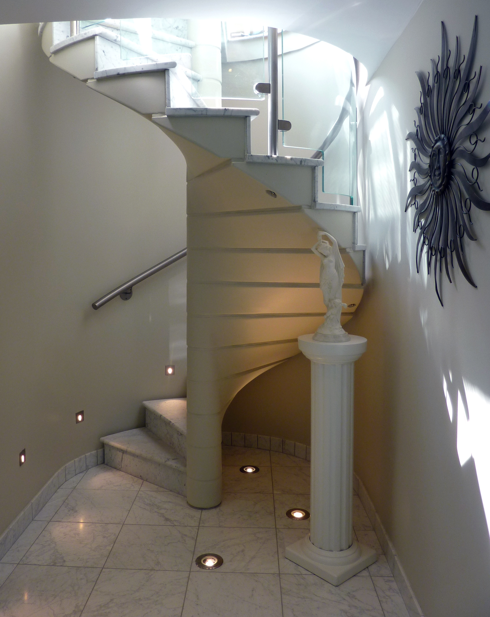 New stone tread staircase in extensions with glass balustrades and metal railings