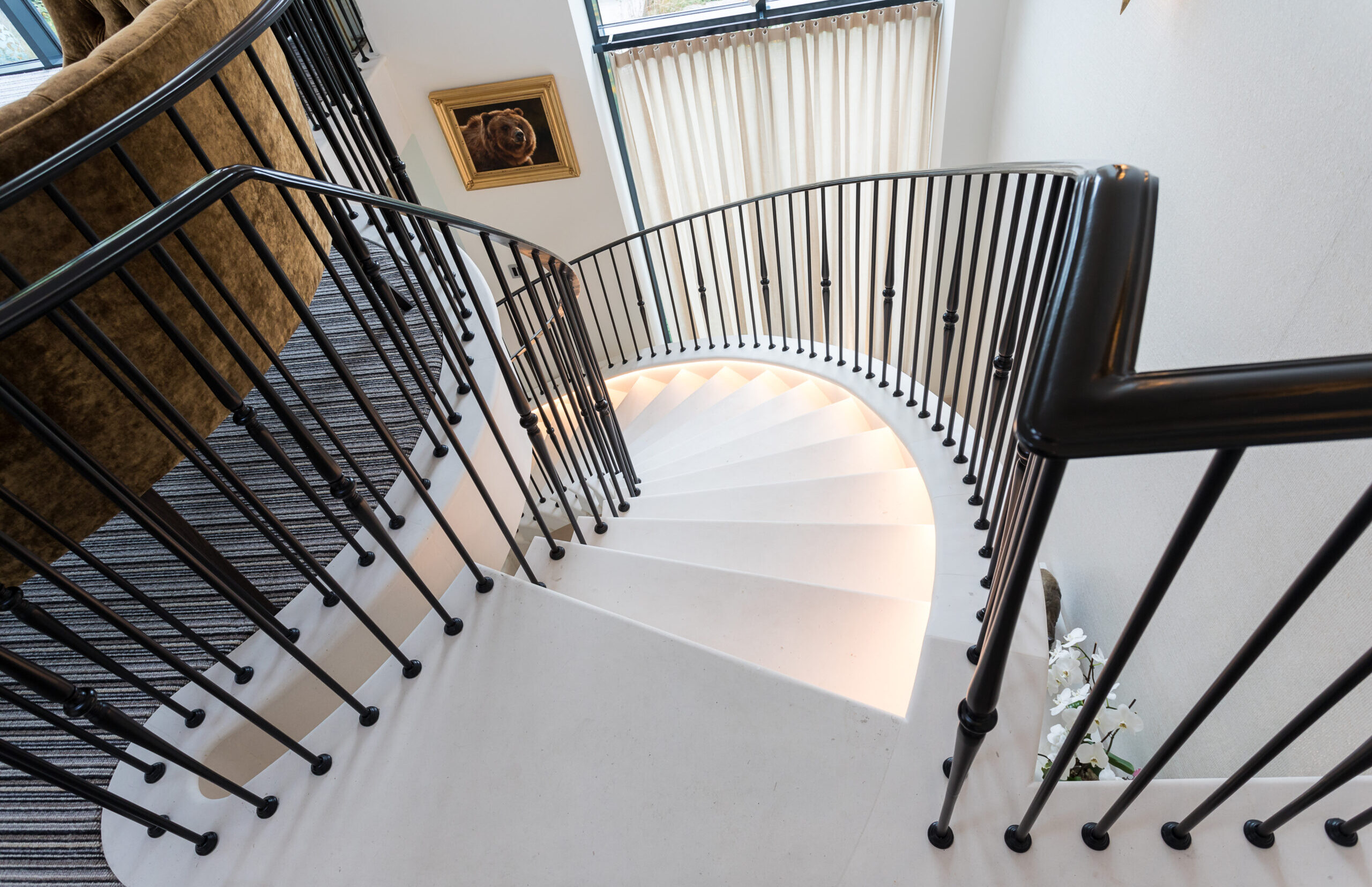Ash House staircase stone staircase to games room with metal balustrade and handrails and concealed step lighting
