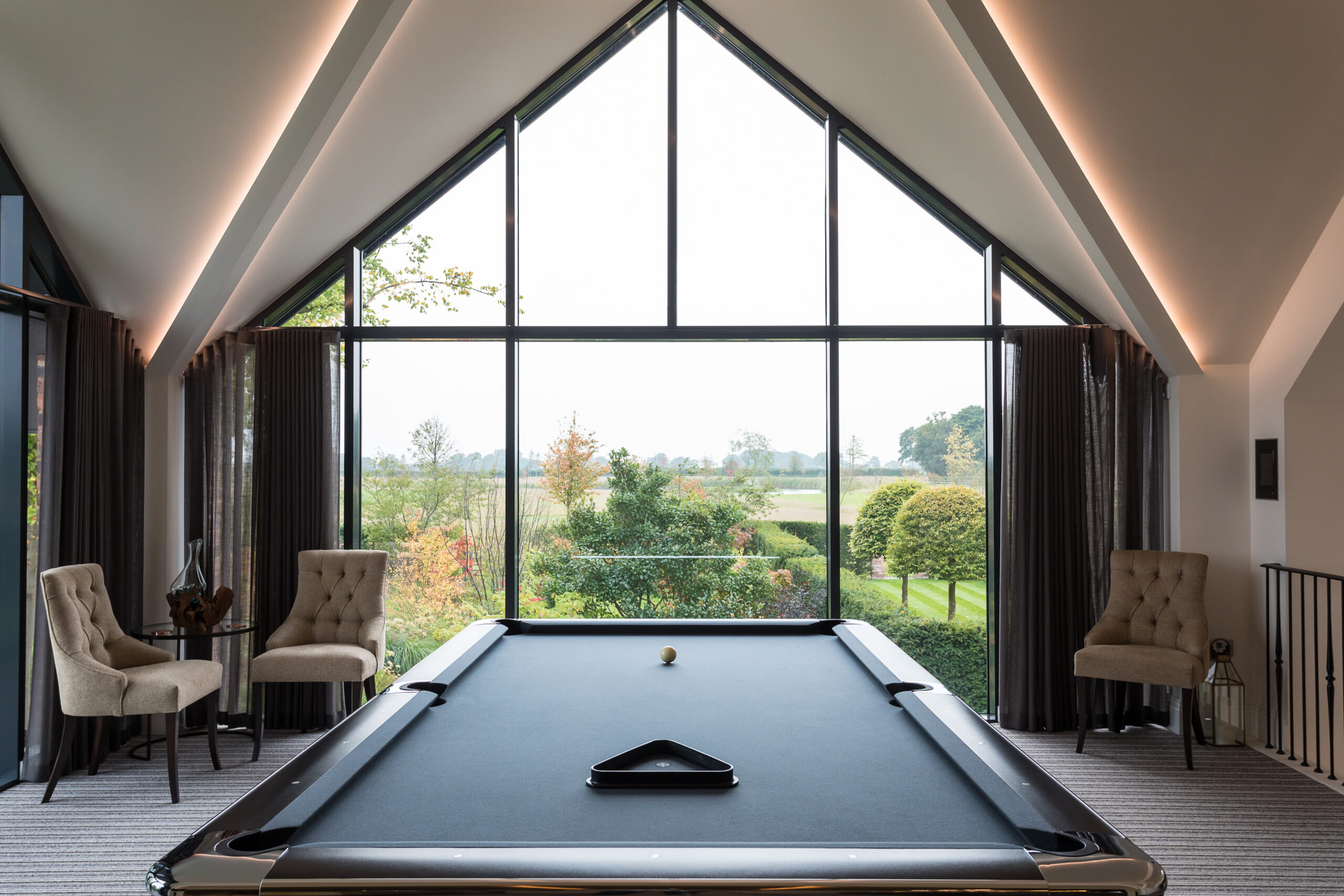 view from the games room with pool table looking out over surrounding garden and countryside