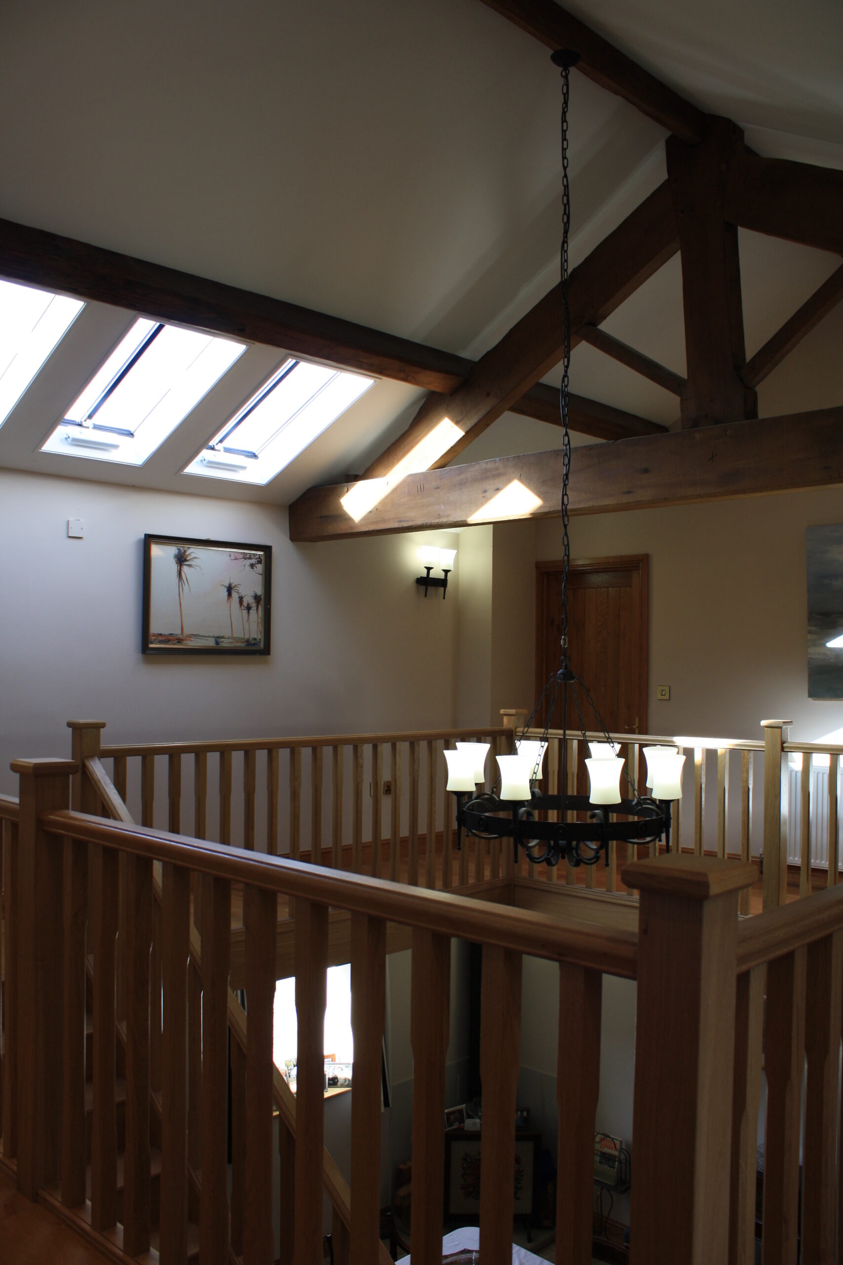 galleried landing at Moor Hall Farm with exposed roof trusses and purlins with row of rooflights