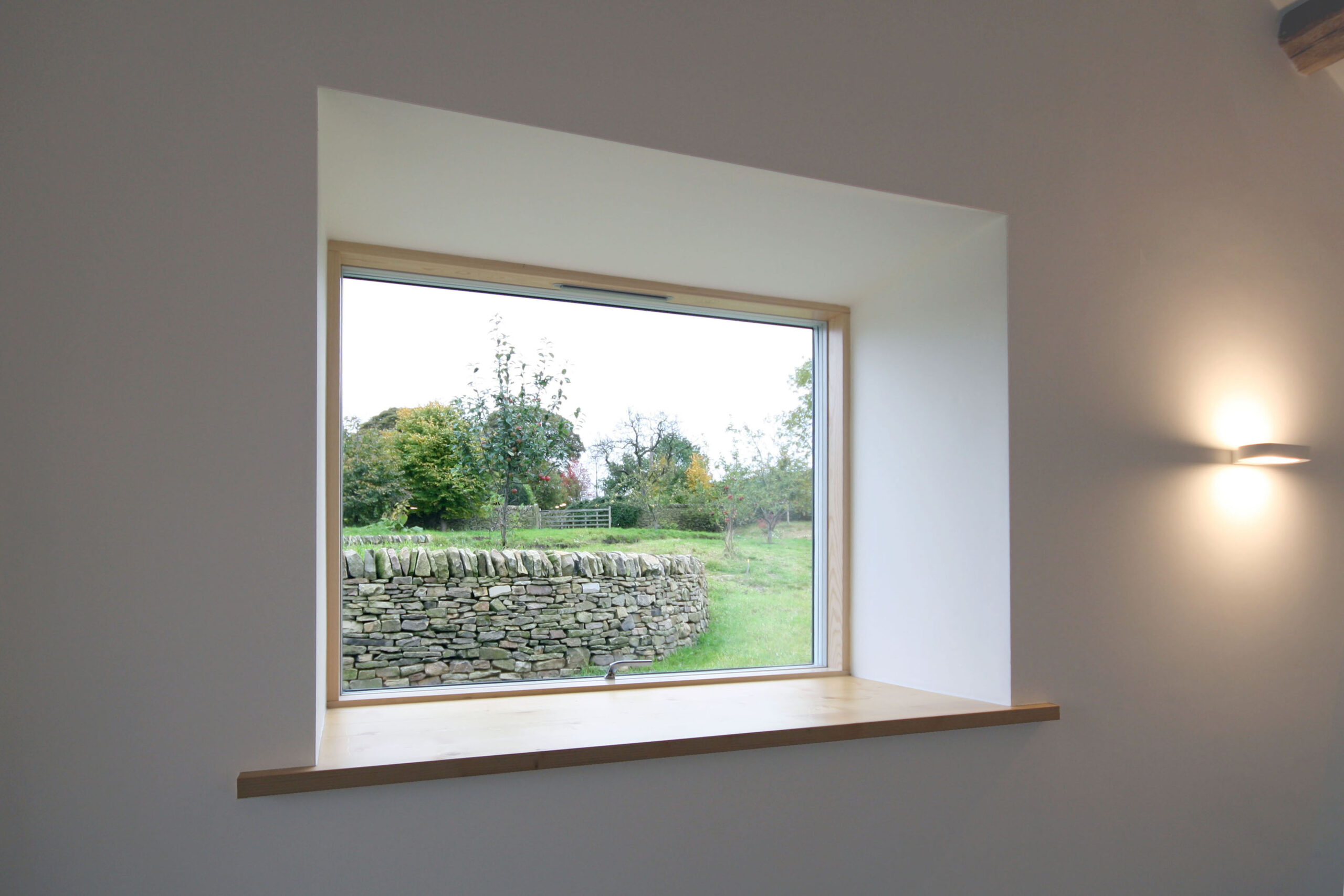 retained openings in barn conversion with views of surrounding gardens