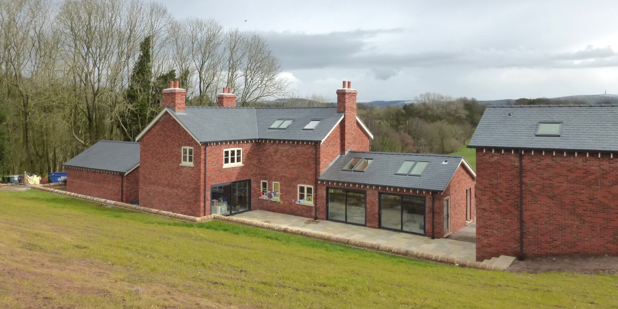 view from top of bank down to Hazelwall Cottage with large opening to open plan living space and sitting room