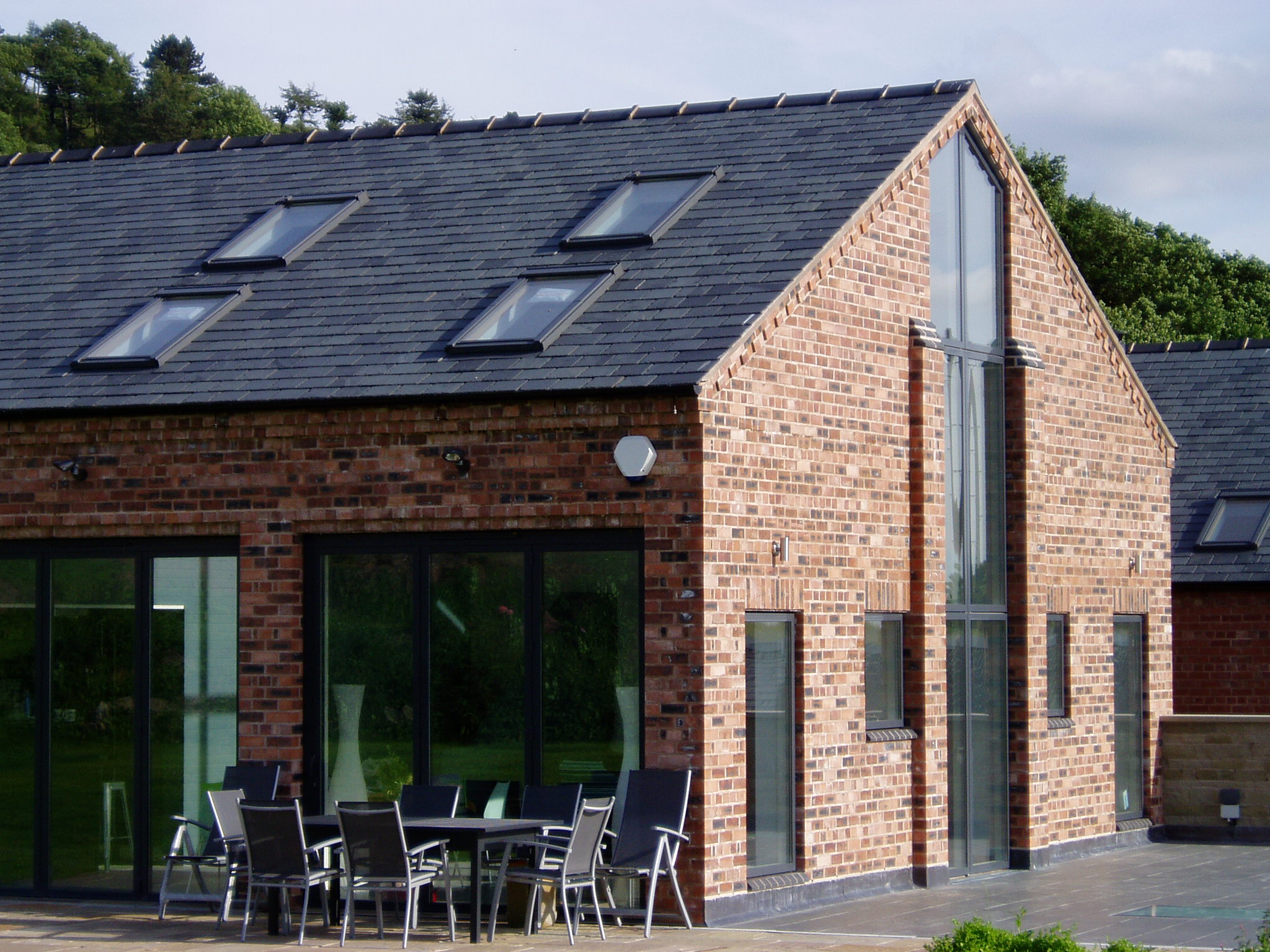 converted brick barn with large glazed openings and rooflights