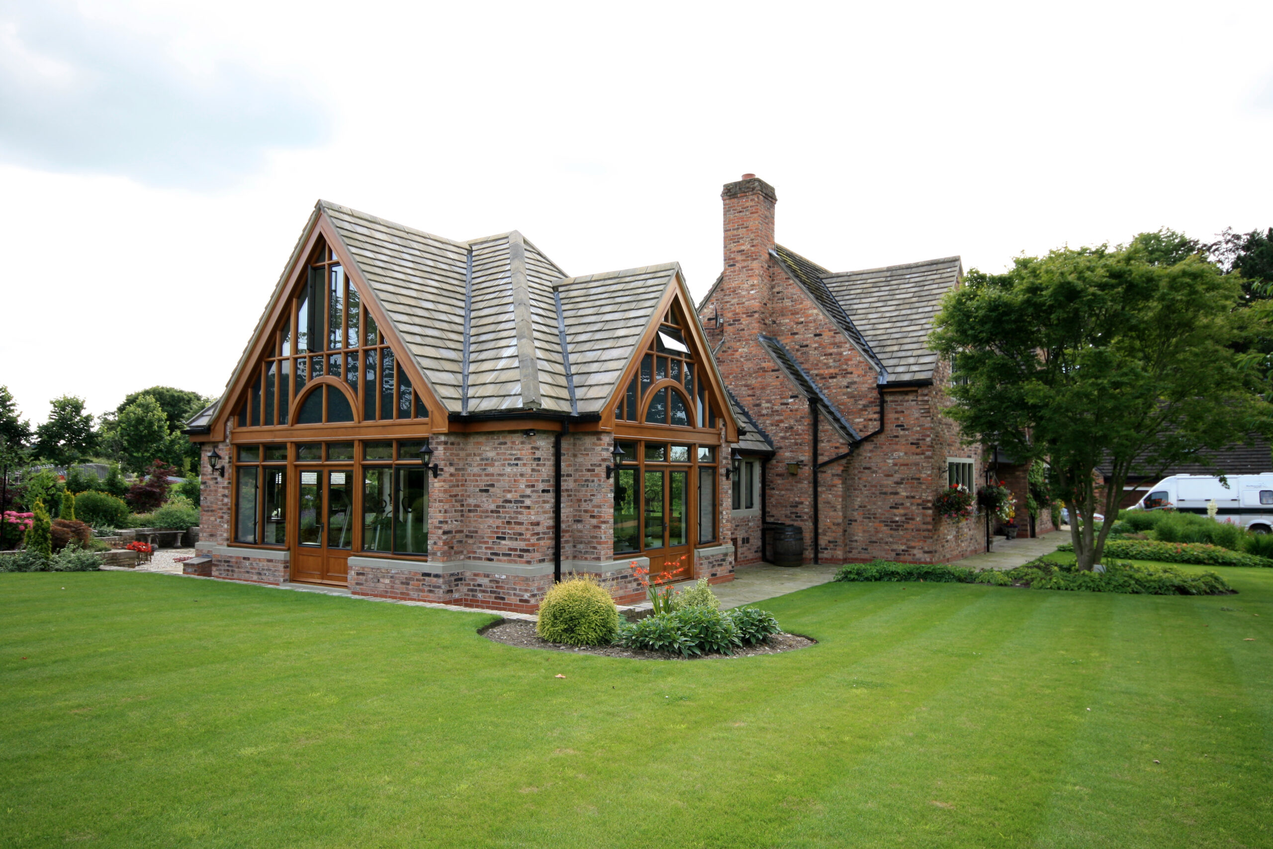 new side extensions set back from the dwellinghouse with large gable end glazing