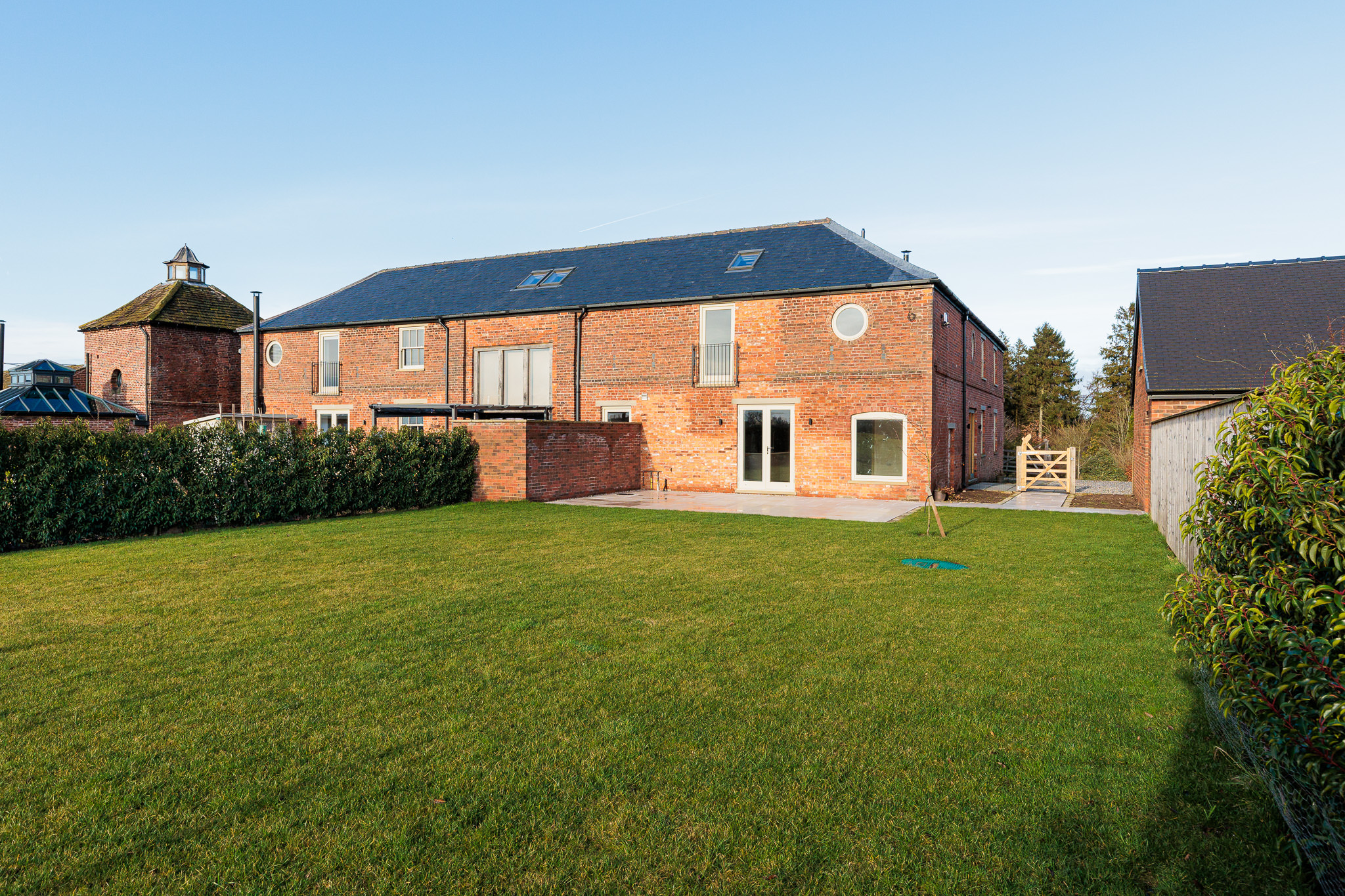 rear elevation of Coach House Unit 2 with eixsting opening retained and new rear patio area on to garden