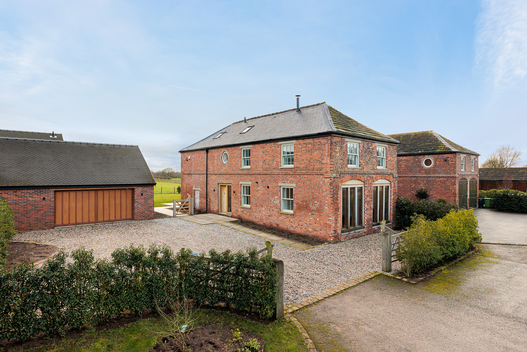 Coach House barn conversion with existing opening retained and new detached garage building