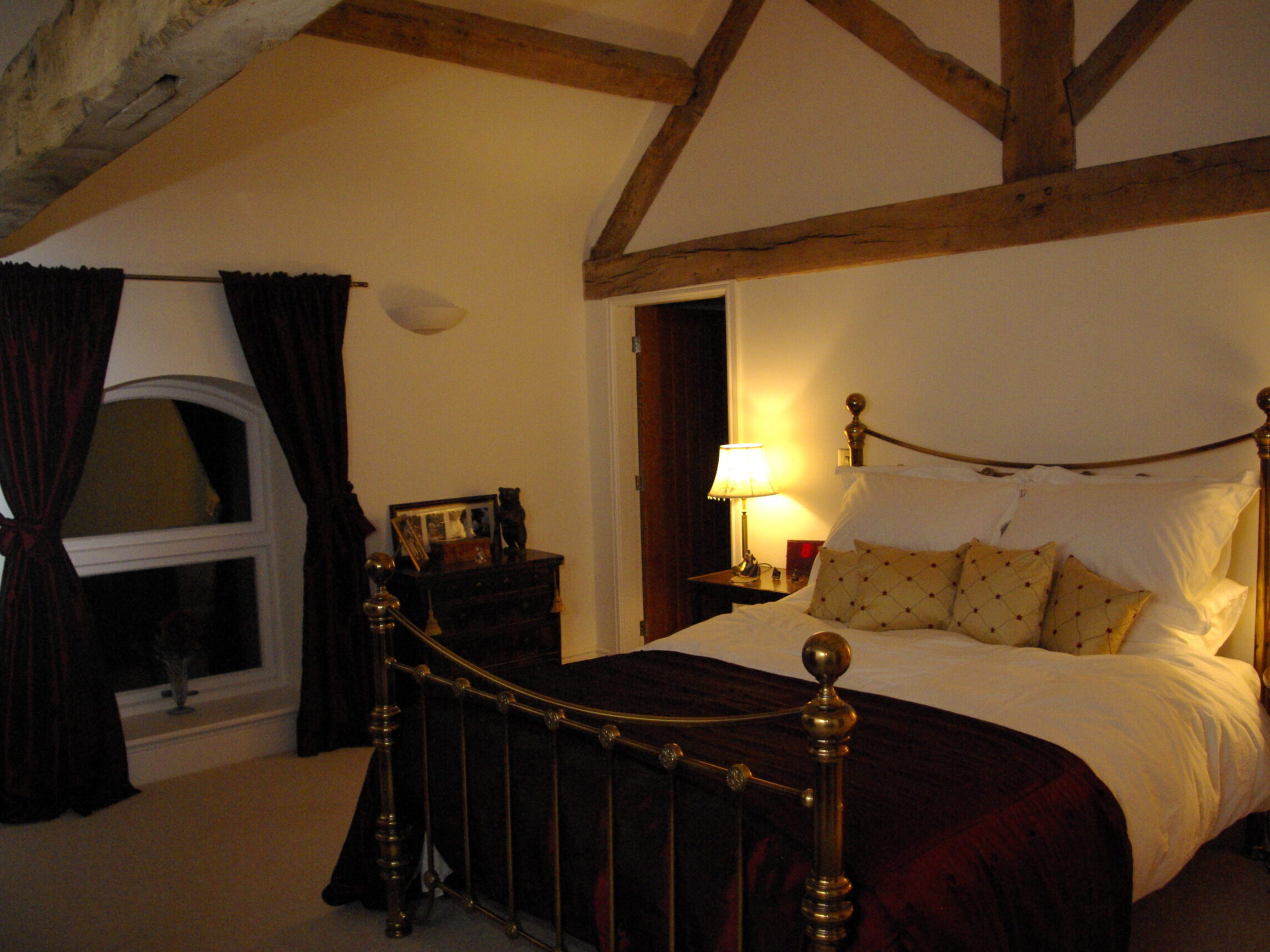exposed timber roof trusses and purlins in bedroom