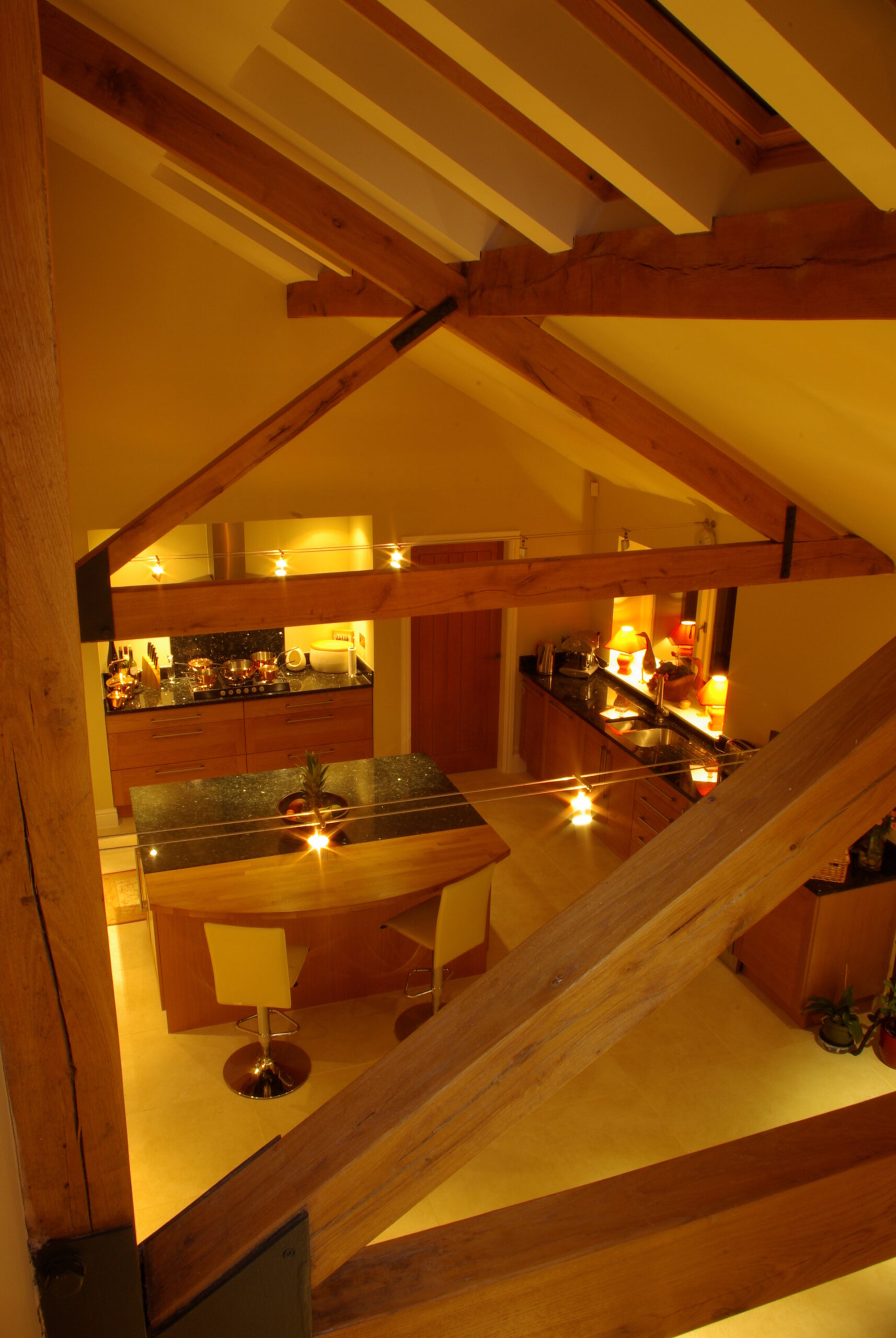 Large raked ceiling over open plan living space with new exposed timber roof trusses and rooflights over